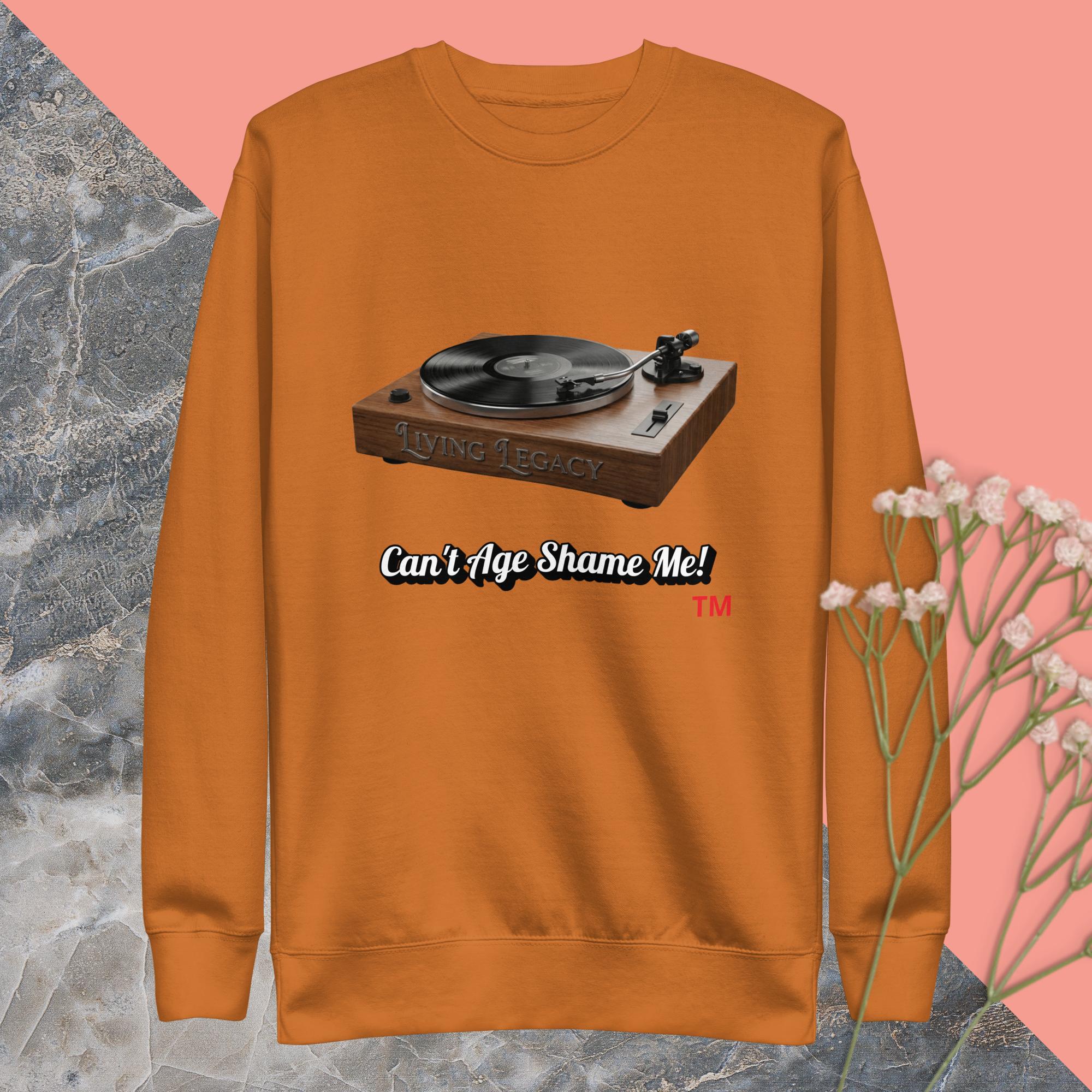 adobe sweatshirt with a record player graphic and text on a pink and gray marble background.