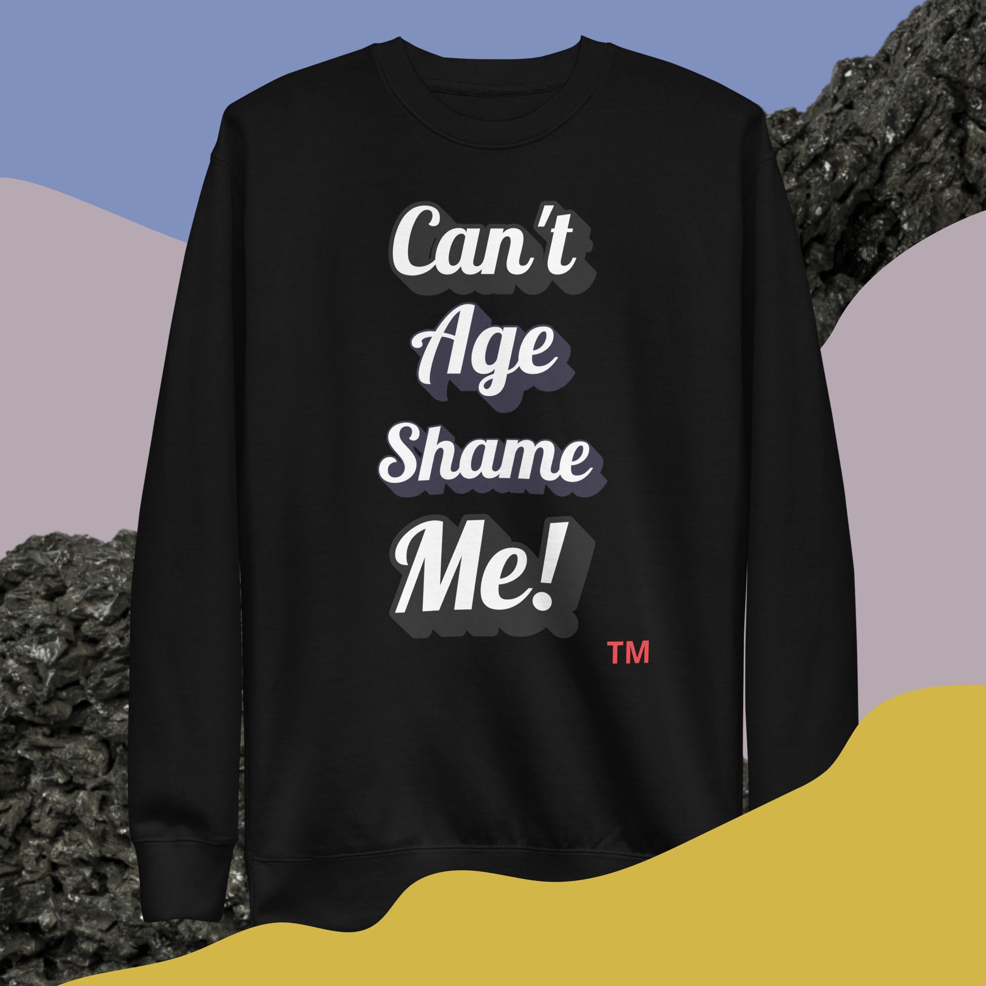 Black sweatshirt with 'Can't Age Shame Me!' text on a colorful background