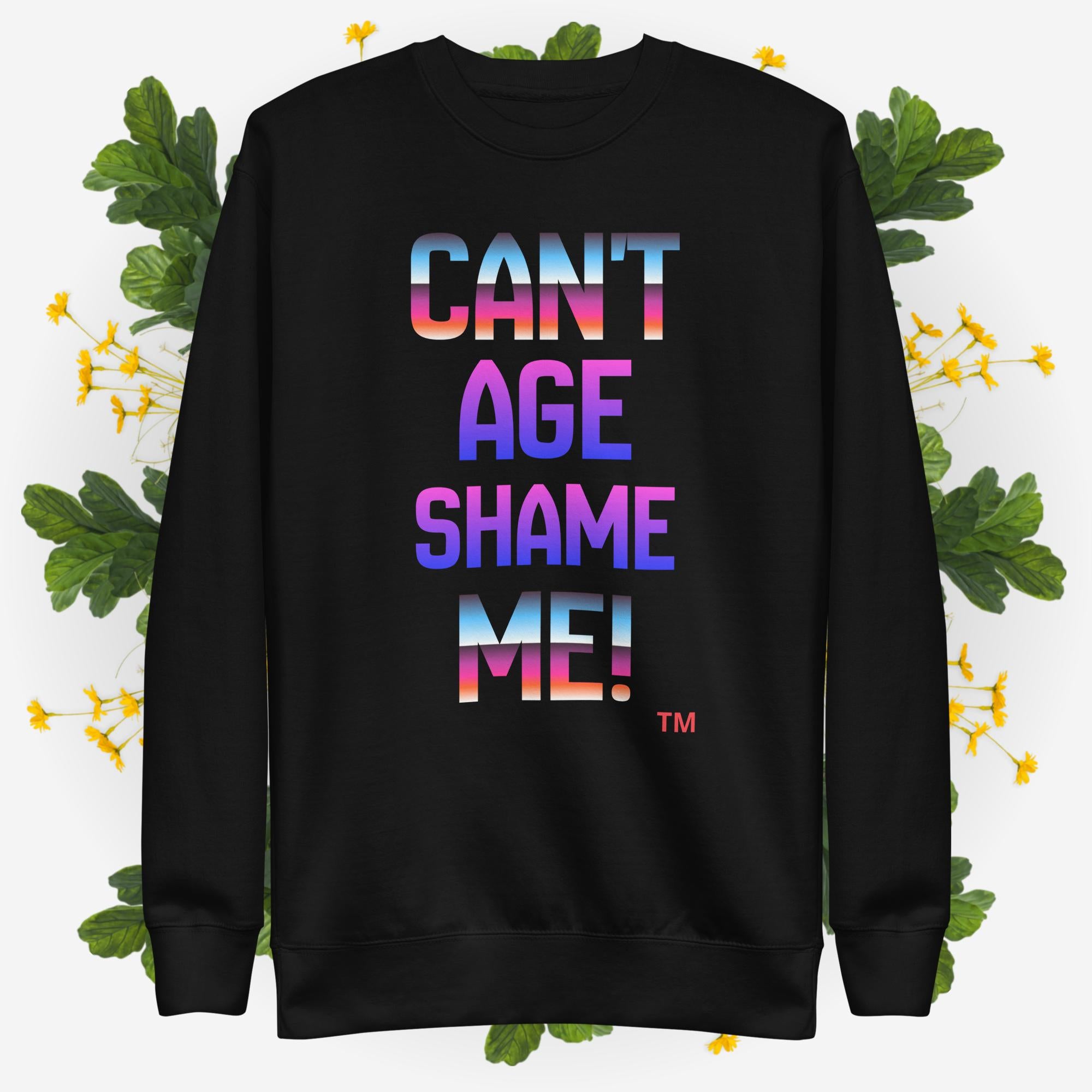 Black sweatshirt with colorful text 'CAN'T AGE SHAME ME!' on a floral background