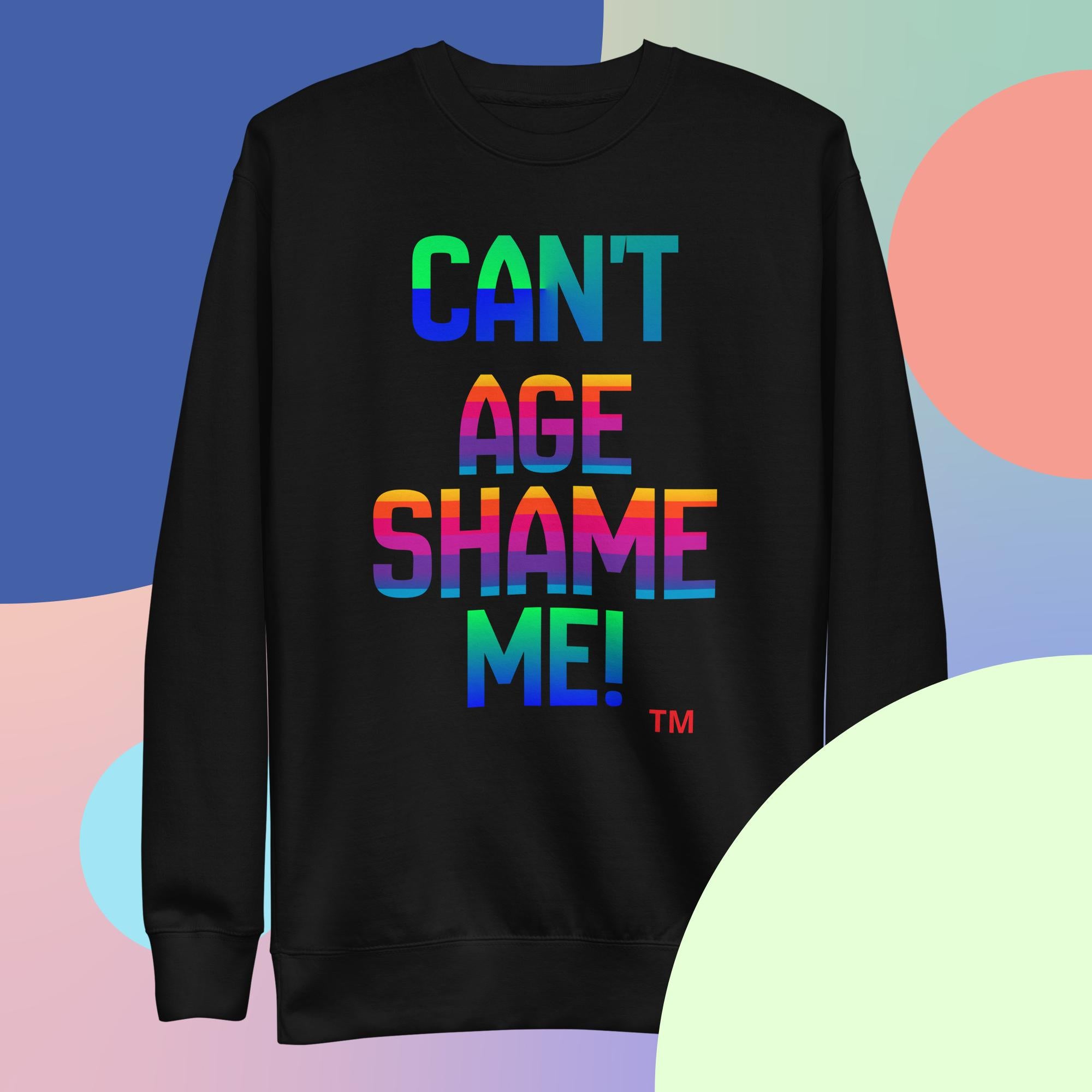 Black sweatshirt with colorful text 'CAN'T AGE SHAME ME!' on a multicolored background