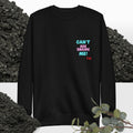 Black sweatshirt with colorful text: 'Can't Age Shame Me'  on a background with black rocks and greenery.