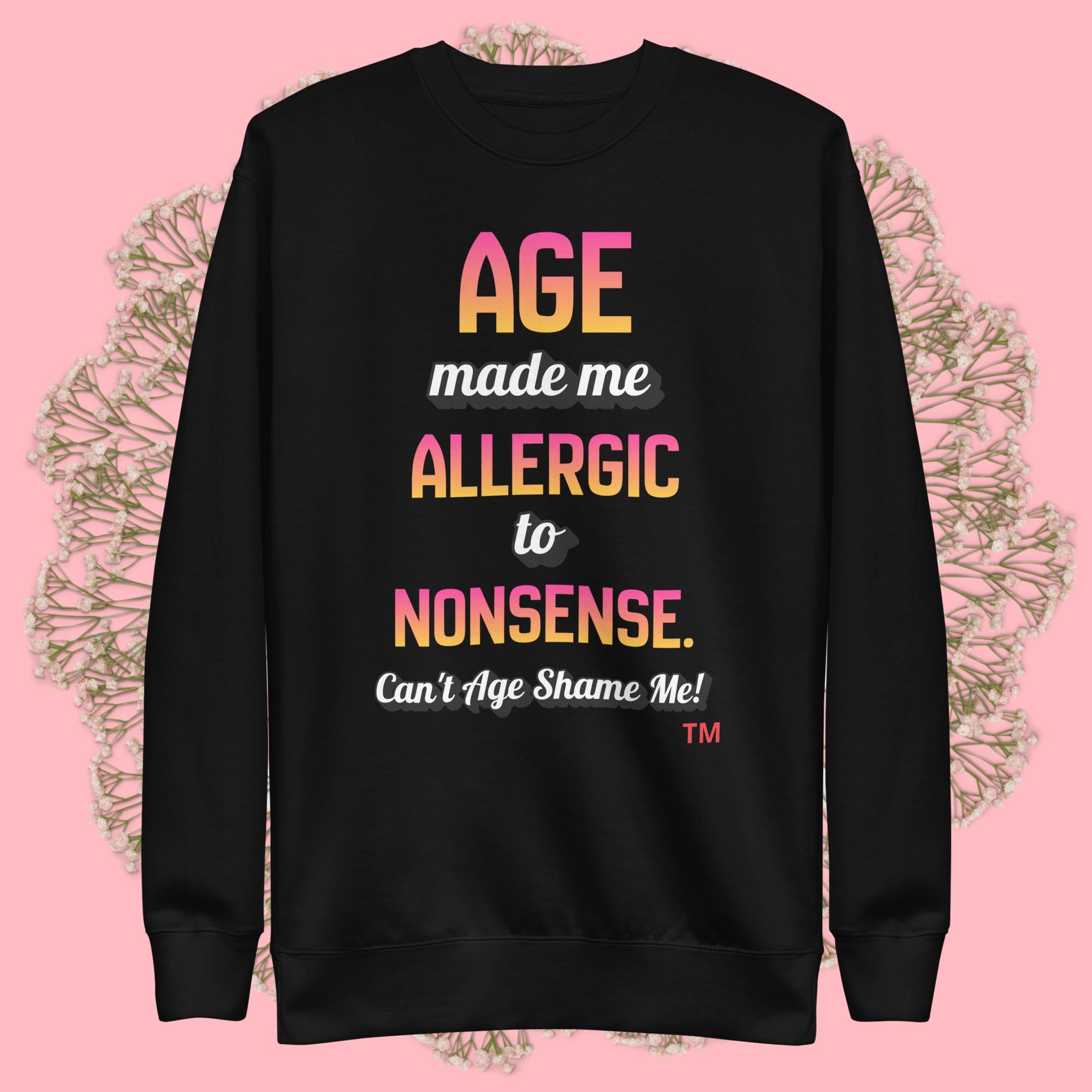 Black sweatshirt with colorful text on a pink background