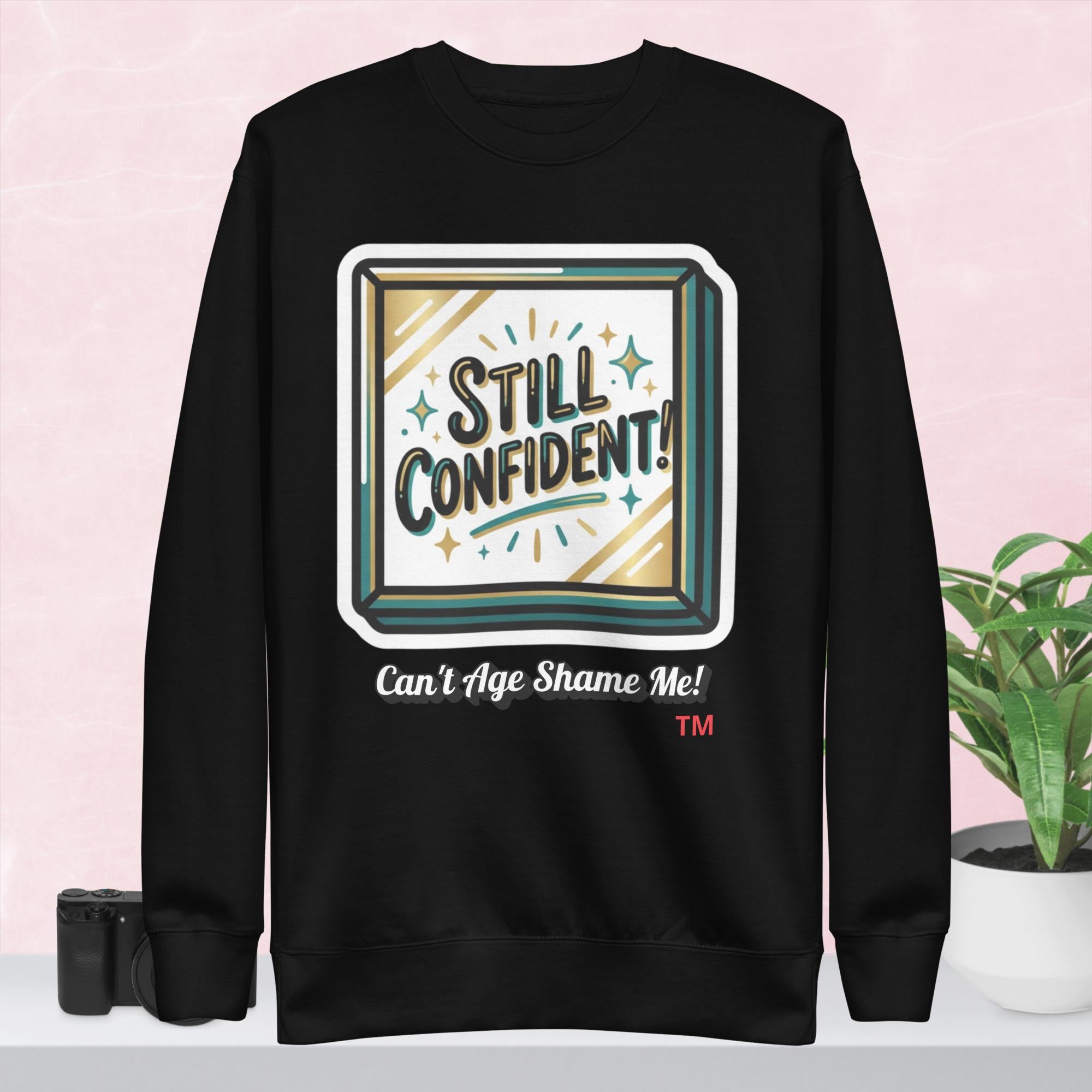Black hoodie with 'Still Confident' graphic on a colorful background