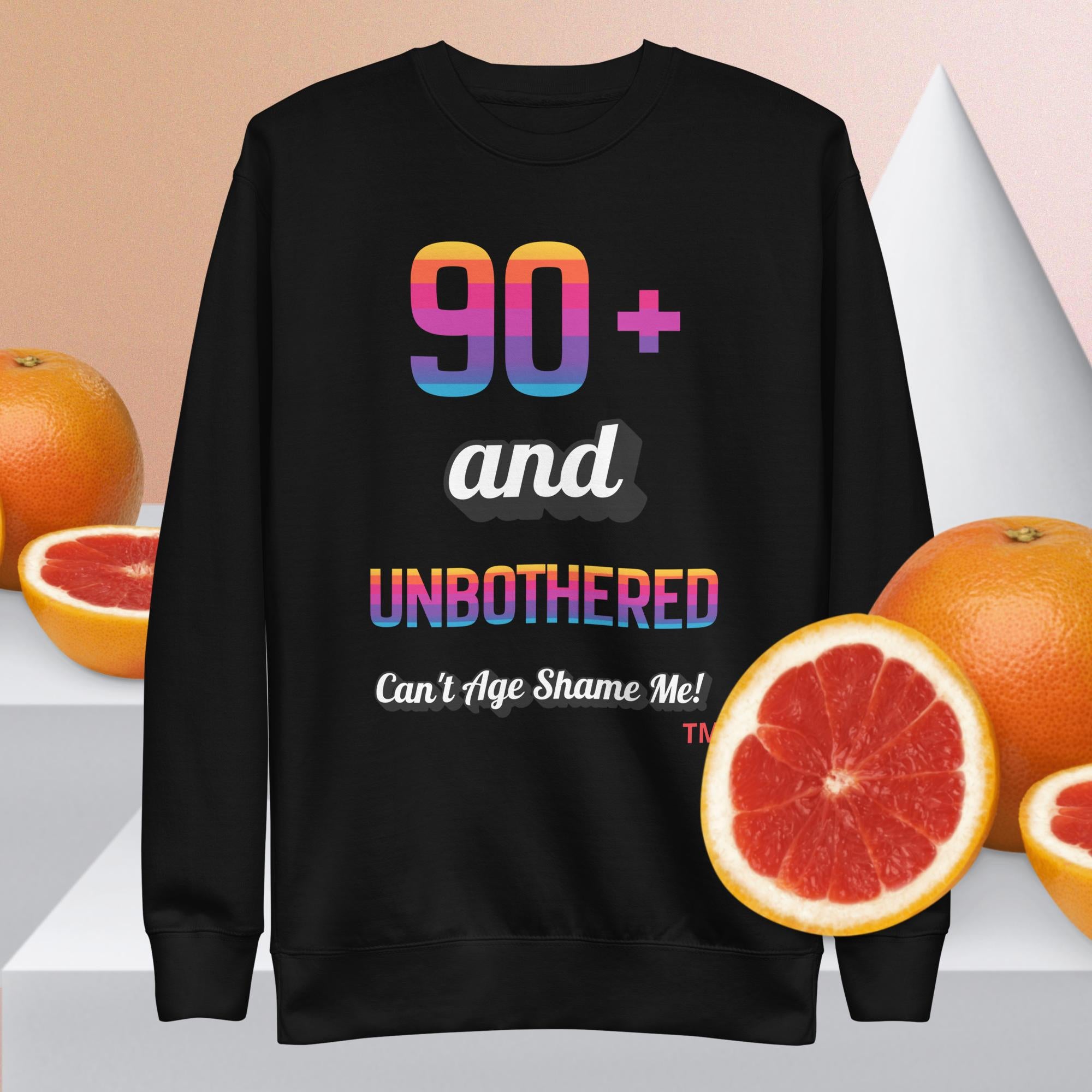 Black sweatshirt with colorful text and grapefruits on a light background