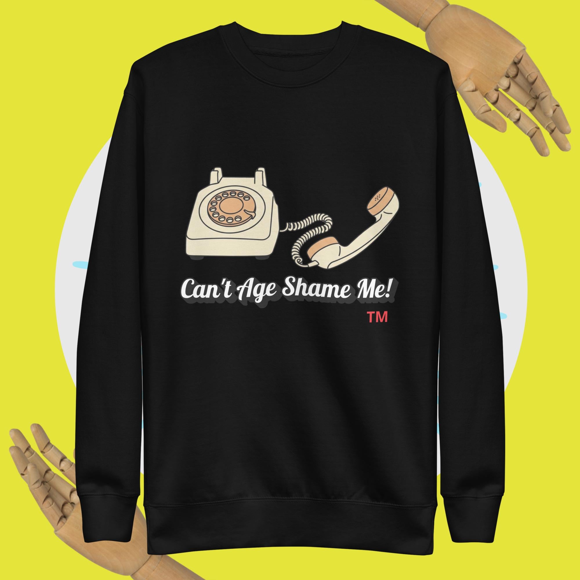 Black sweatshirt with a vintage phone graphic and text 'Can't Age Shame Me!' on a yellow background.