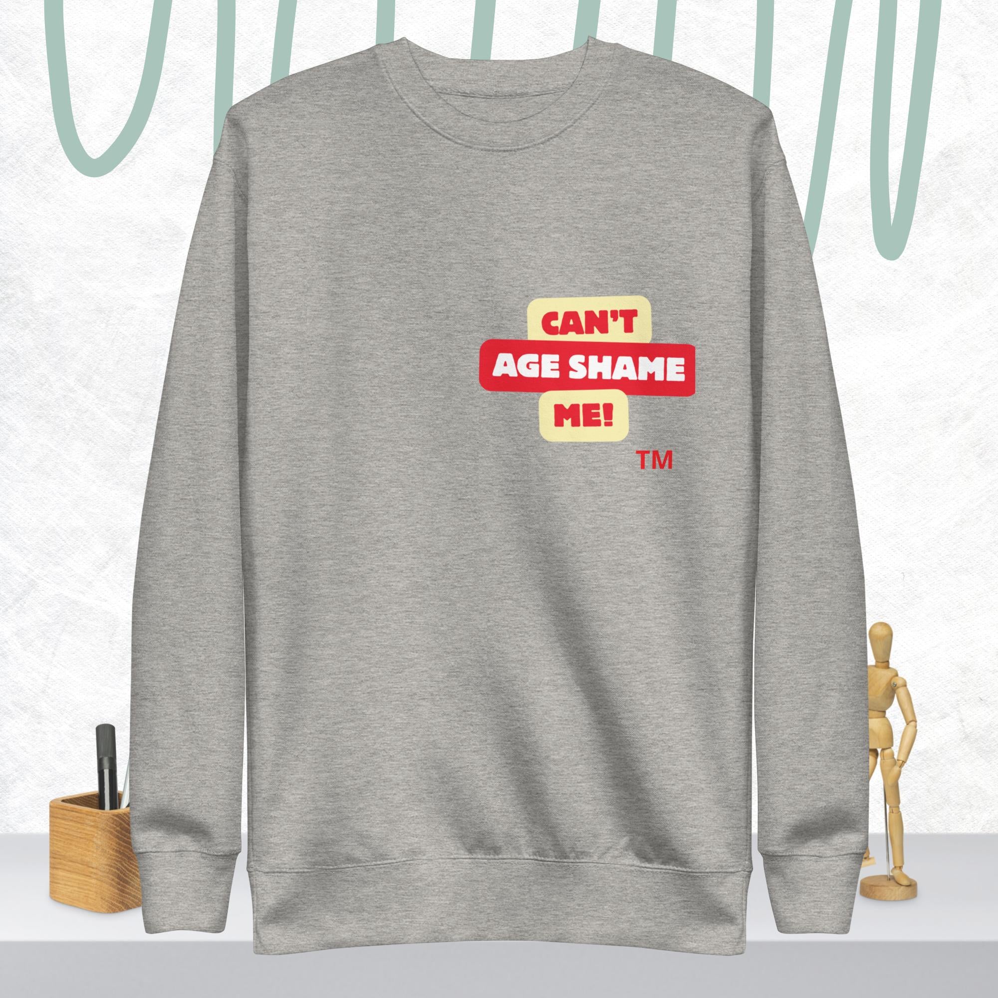 Carbon Gray sweatshirt with 'CAN'T AGE SHAME ME!' text logo on a light gray background