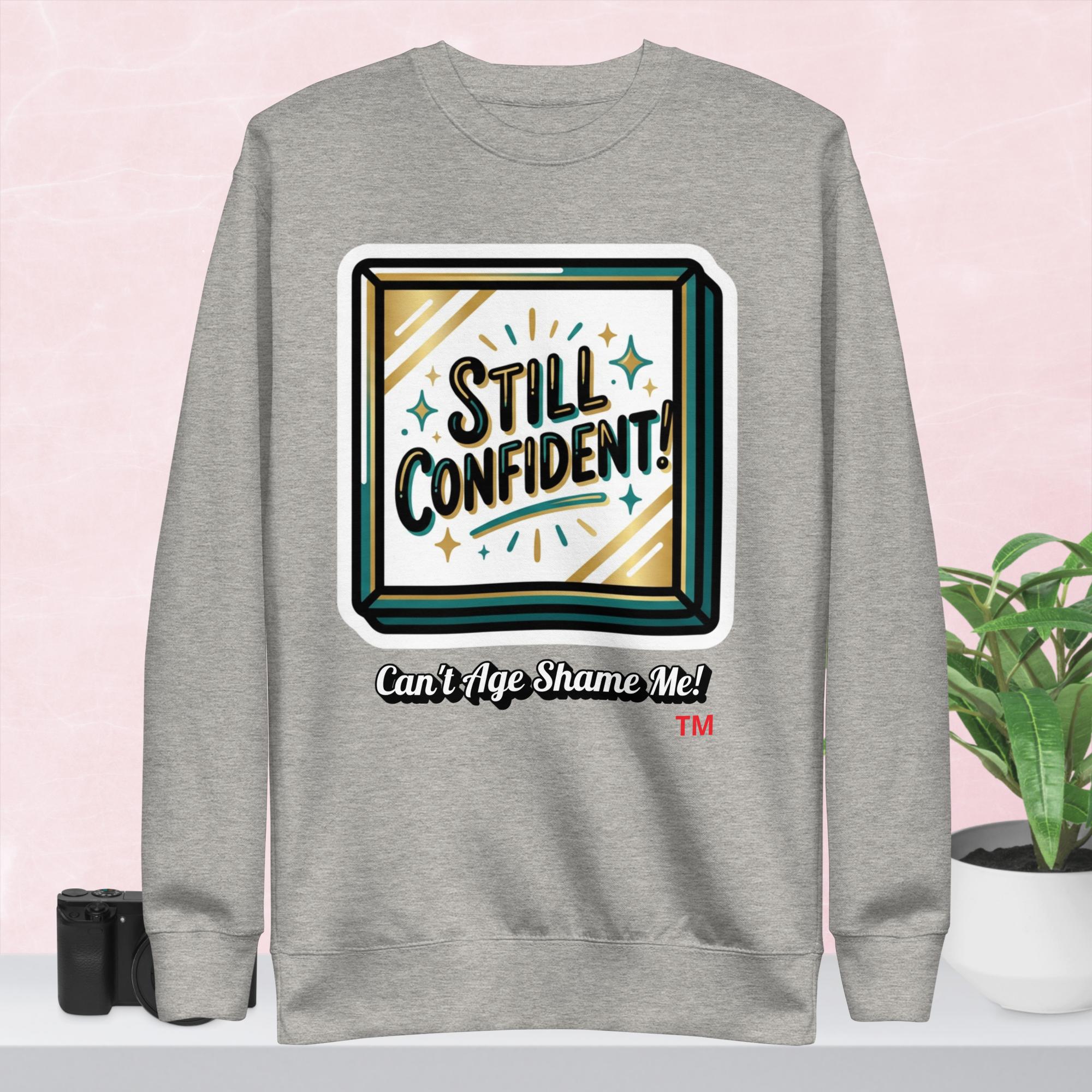 Gray hoodie with 'Still Confident' graphic on a colorful background