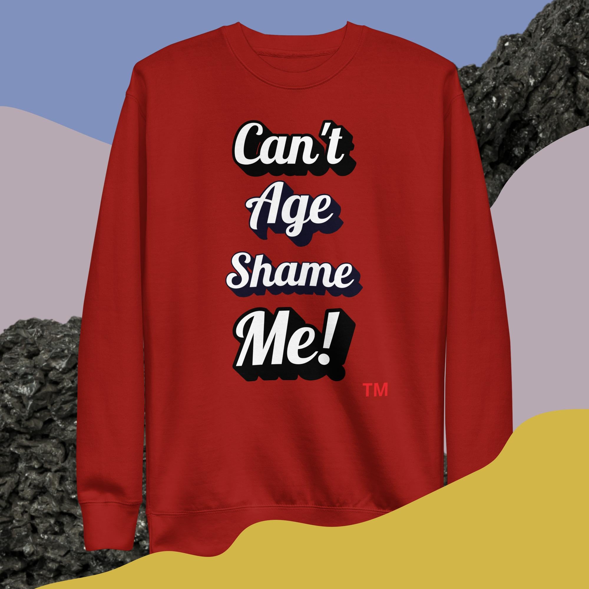 Red sweatshirt with 'Can't Age Shame Me!' text on a colorful background