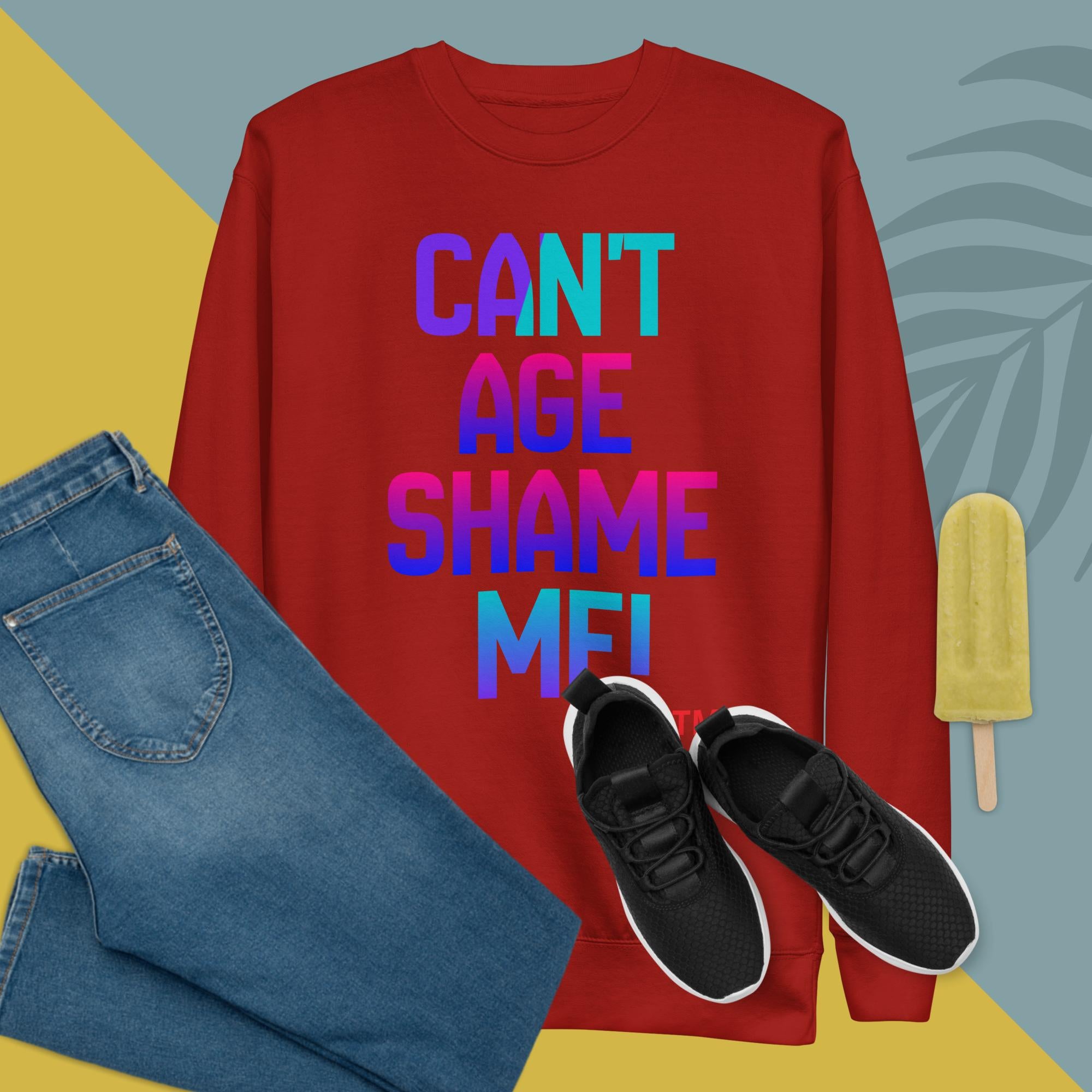 Red sweatshirt with colorful text, blue jeans, black sneakers, and a popsicle on a multicolored background