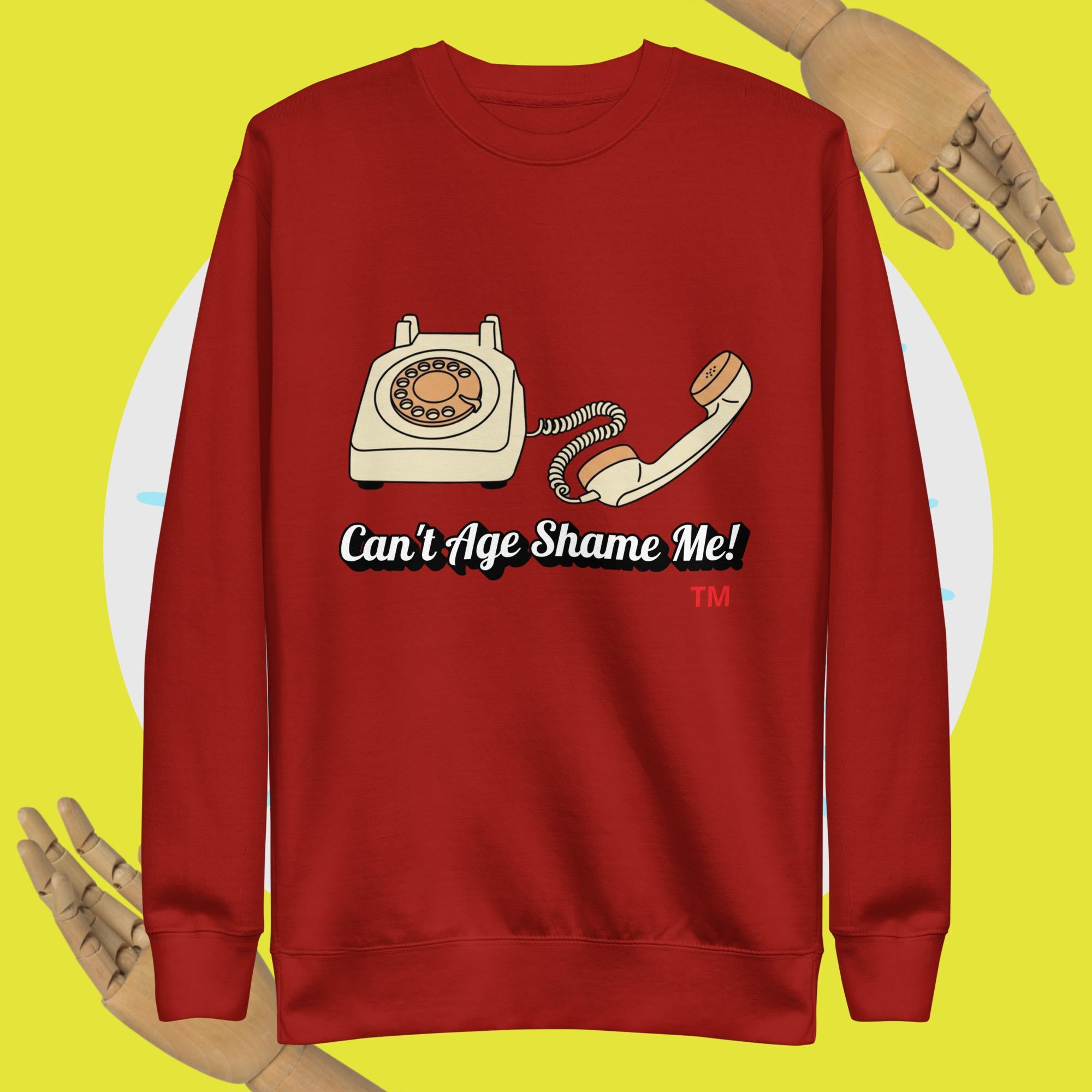 Red sweatshirt with a phone graphic and text 'Can't Age Shame Me!' on a yellow background
