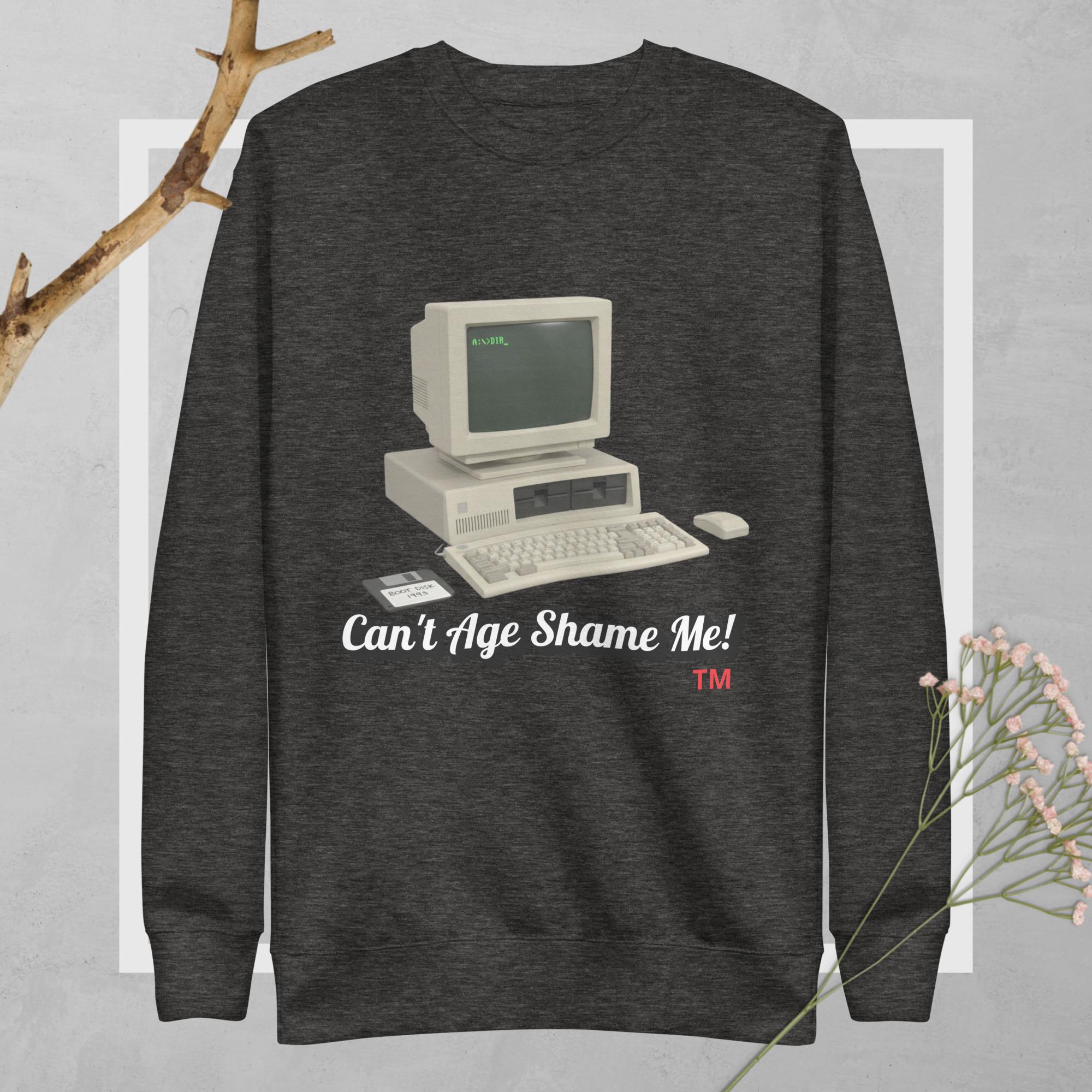 Dark gray sweatshirt with vintage computer graphic and text can't age shame me! on a light gray background