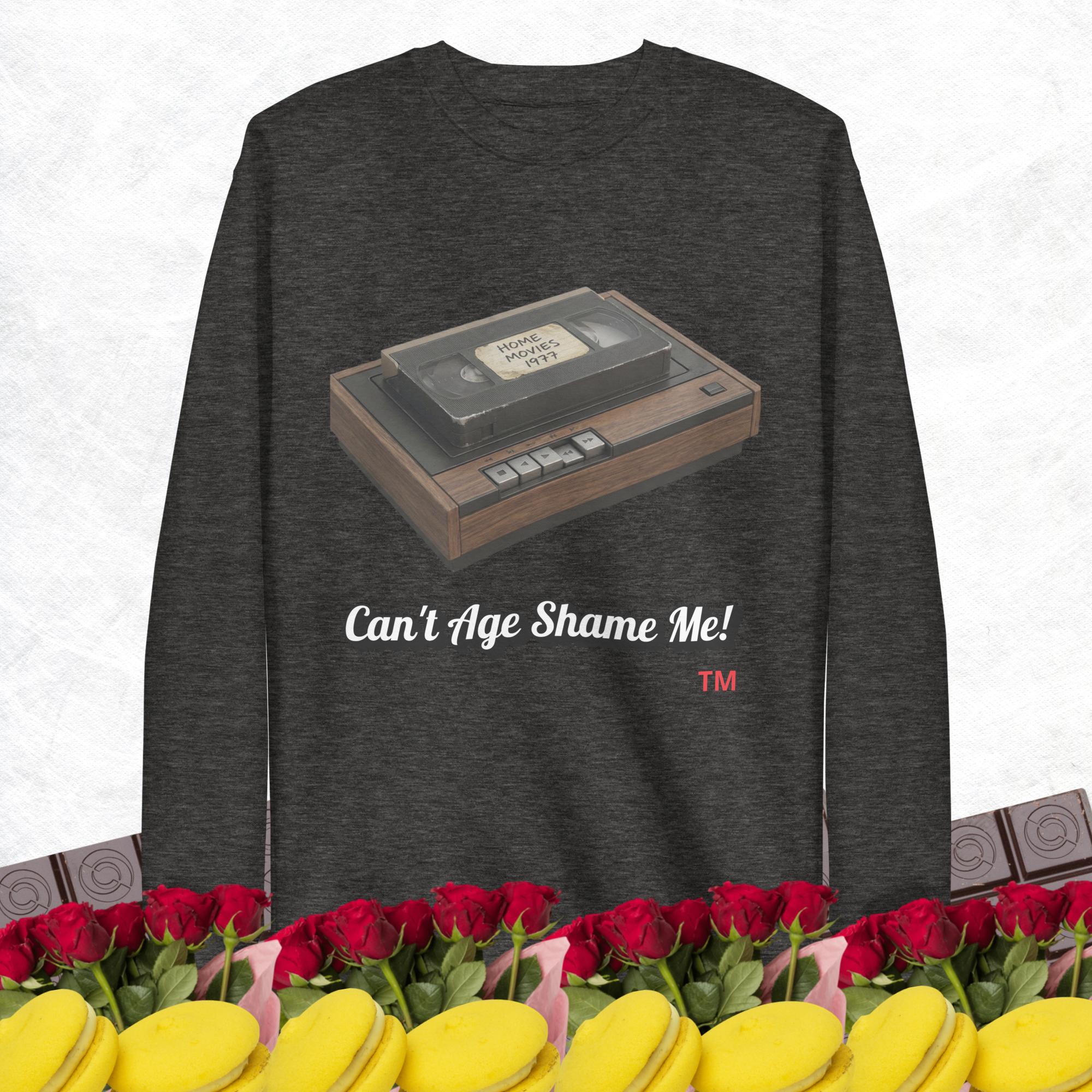 charcoal heather sweatshirt with a vintage VHS player graphic and text 'Can't Age Shame Me!' on a white background.