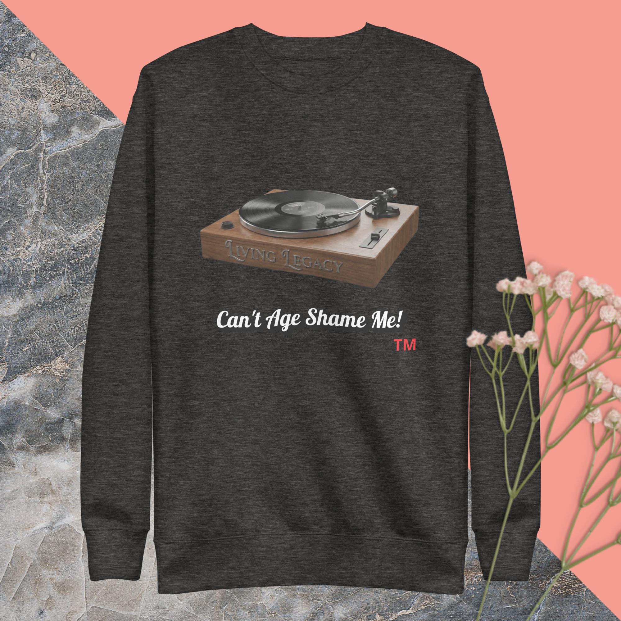 charcoal gray  sweatshirt with a record player graphic and text can't age shame me ! on a pink and gray background
