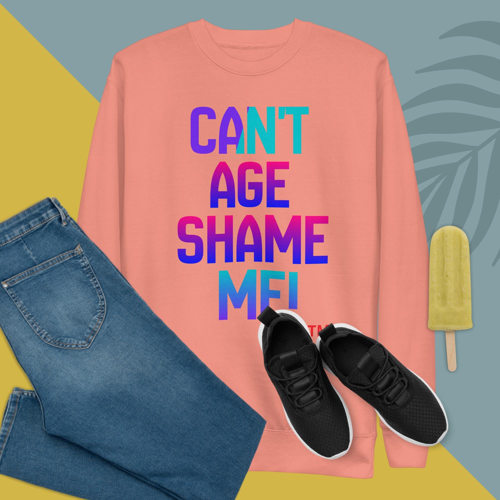 Pink sweatshirt with colorful text, blue jeans, black sneakers, and a popsicle on a multicolored background