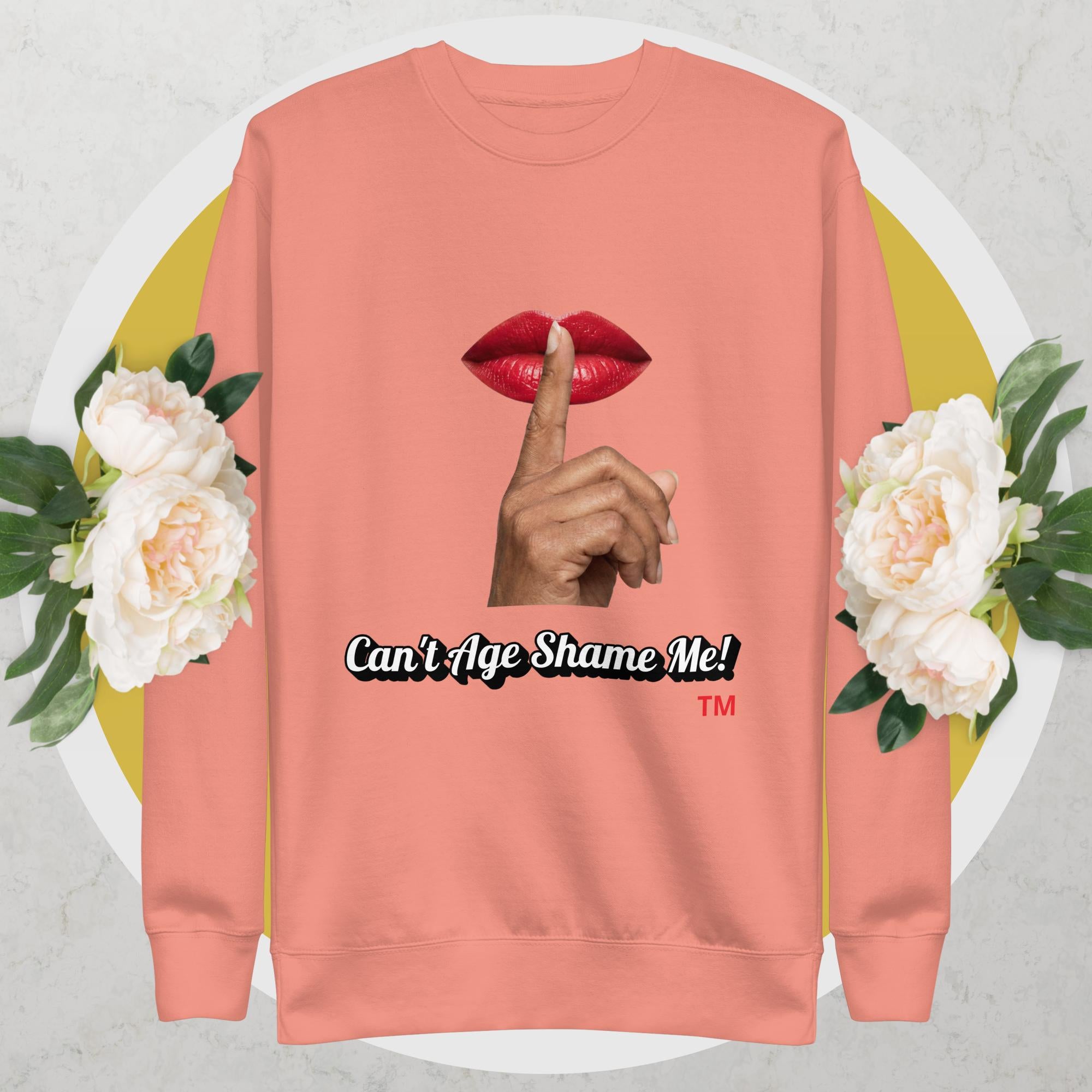 Dusty Rose sweatshirt with graphic design of a hand, lips, and text 'Can't Age Shame Me!' on a floral background.