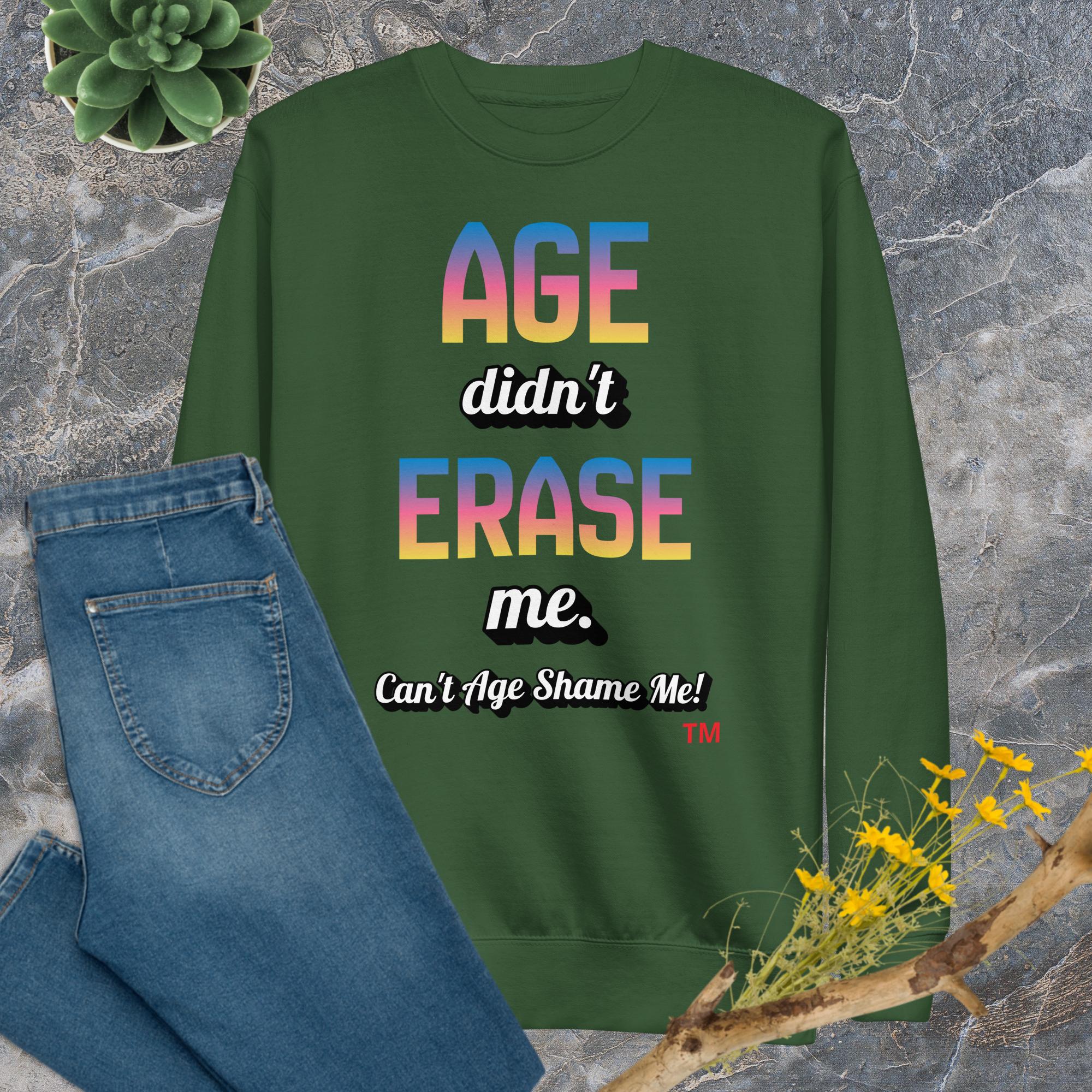 Green sweatshirt with motivational text on a stone surface with jeans and flowers.