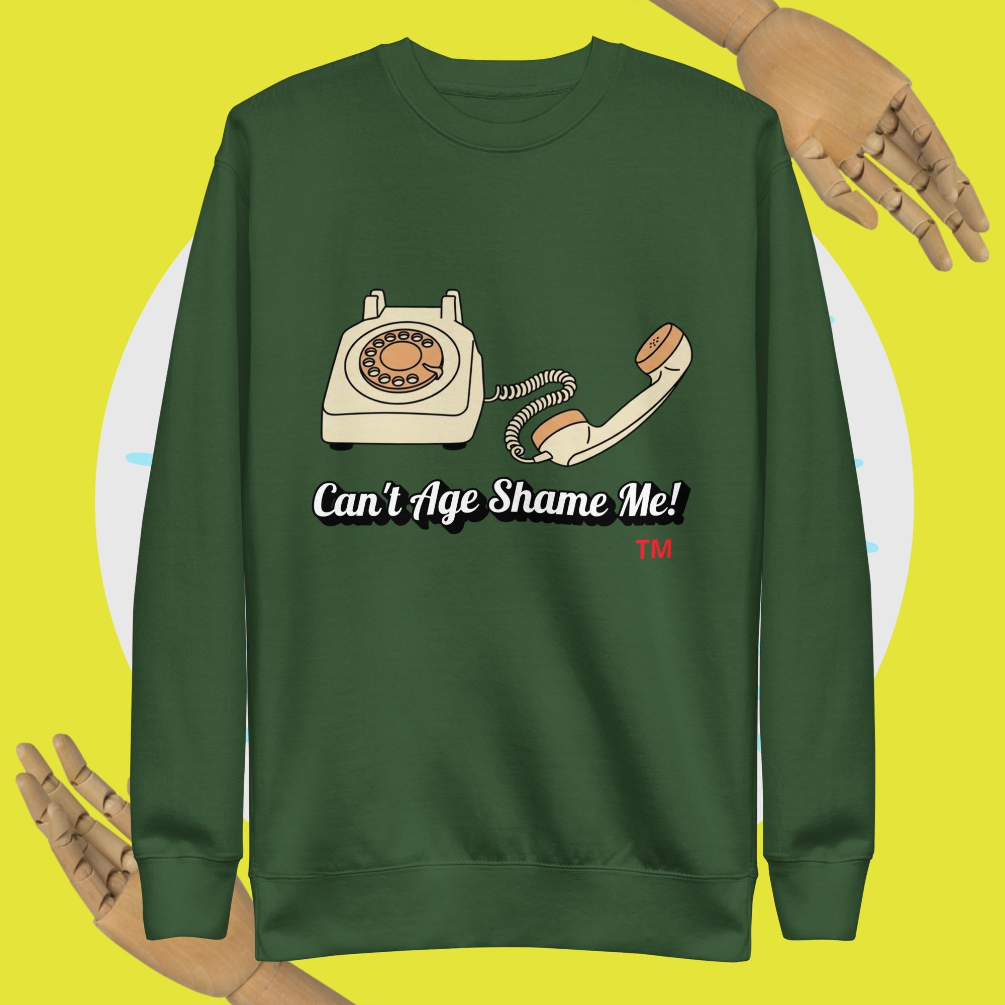 Green sweatshirt with a vintage phone graphic and text 'Can't Age Shame Me!' on a yellow background.