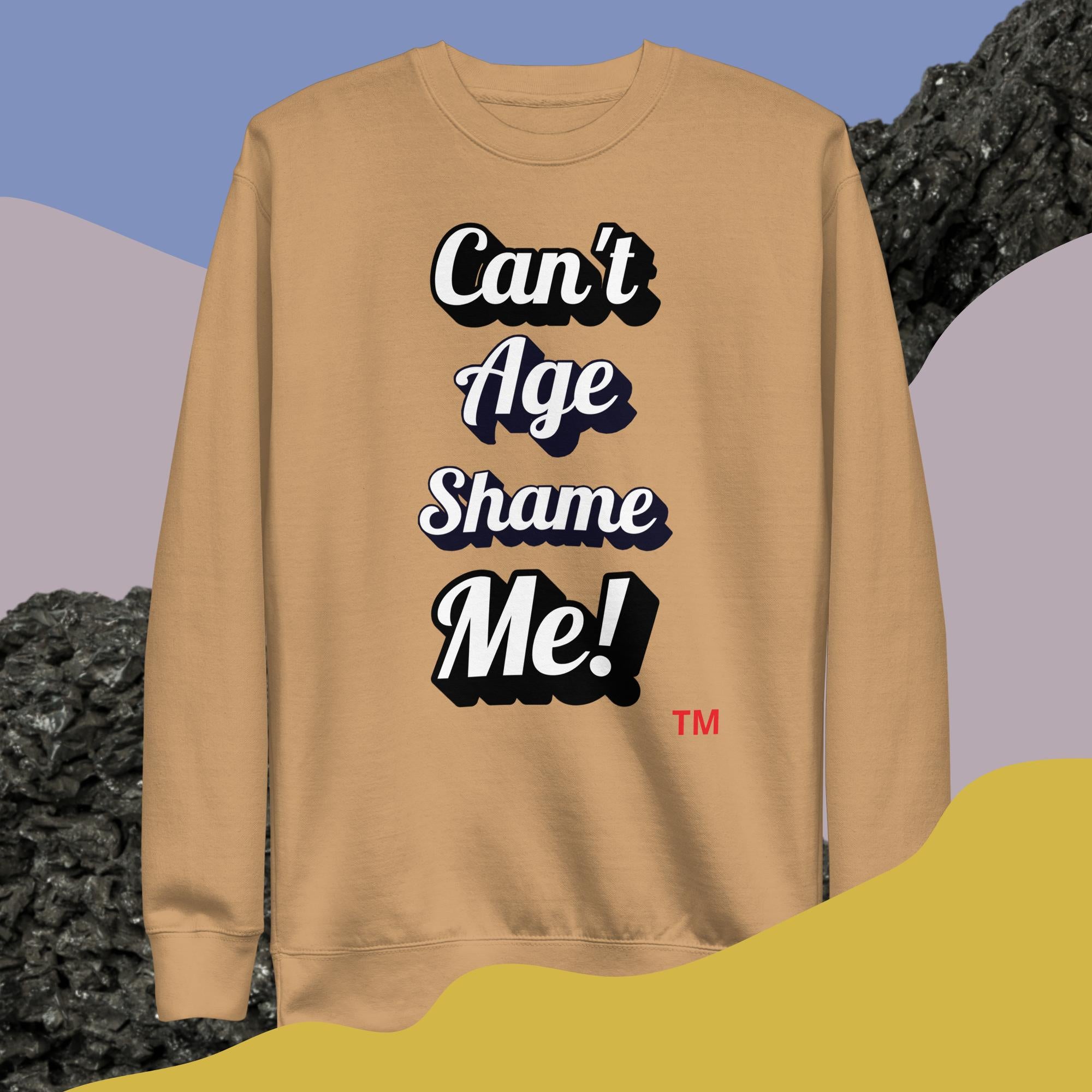 Beige sweatshirt with 'Can't Age Shame Me!' text on a colorful background