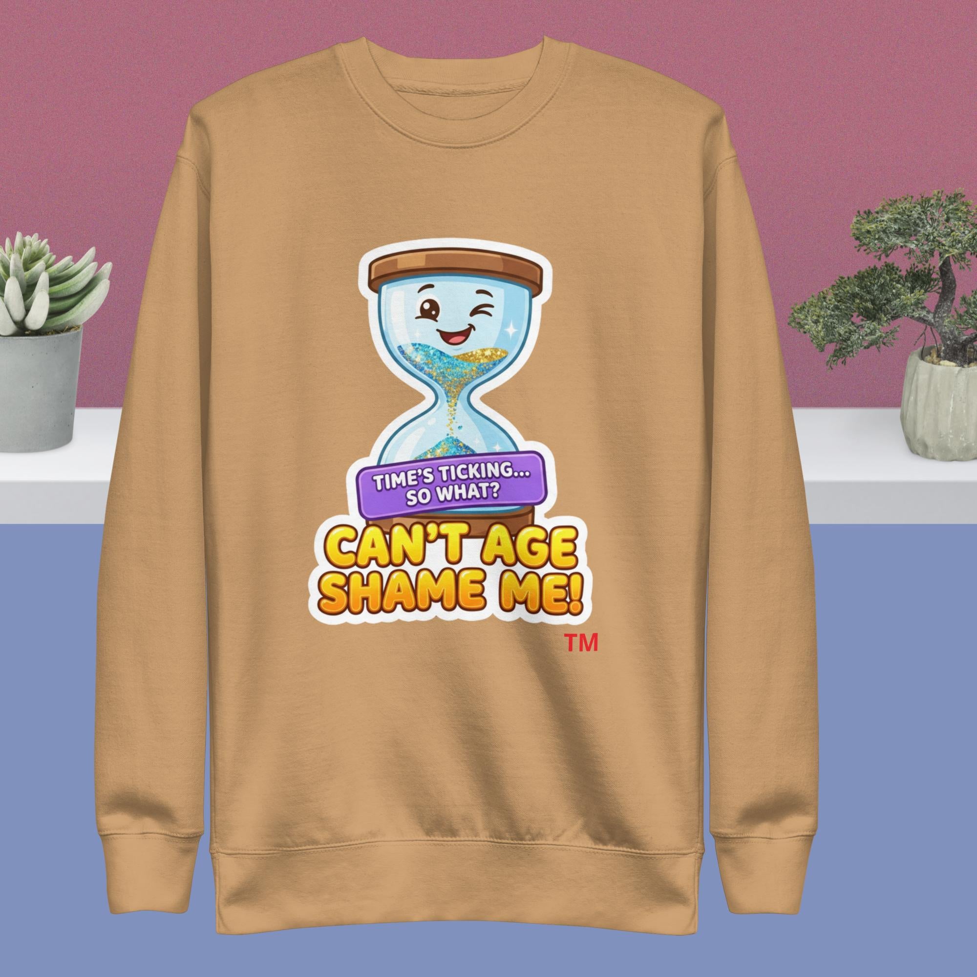 Khaki sweatshirt with a cartoon hourglass design and text on a purple and blue gradient background.