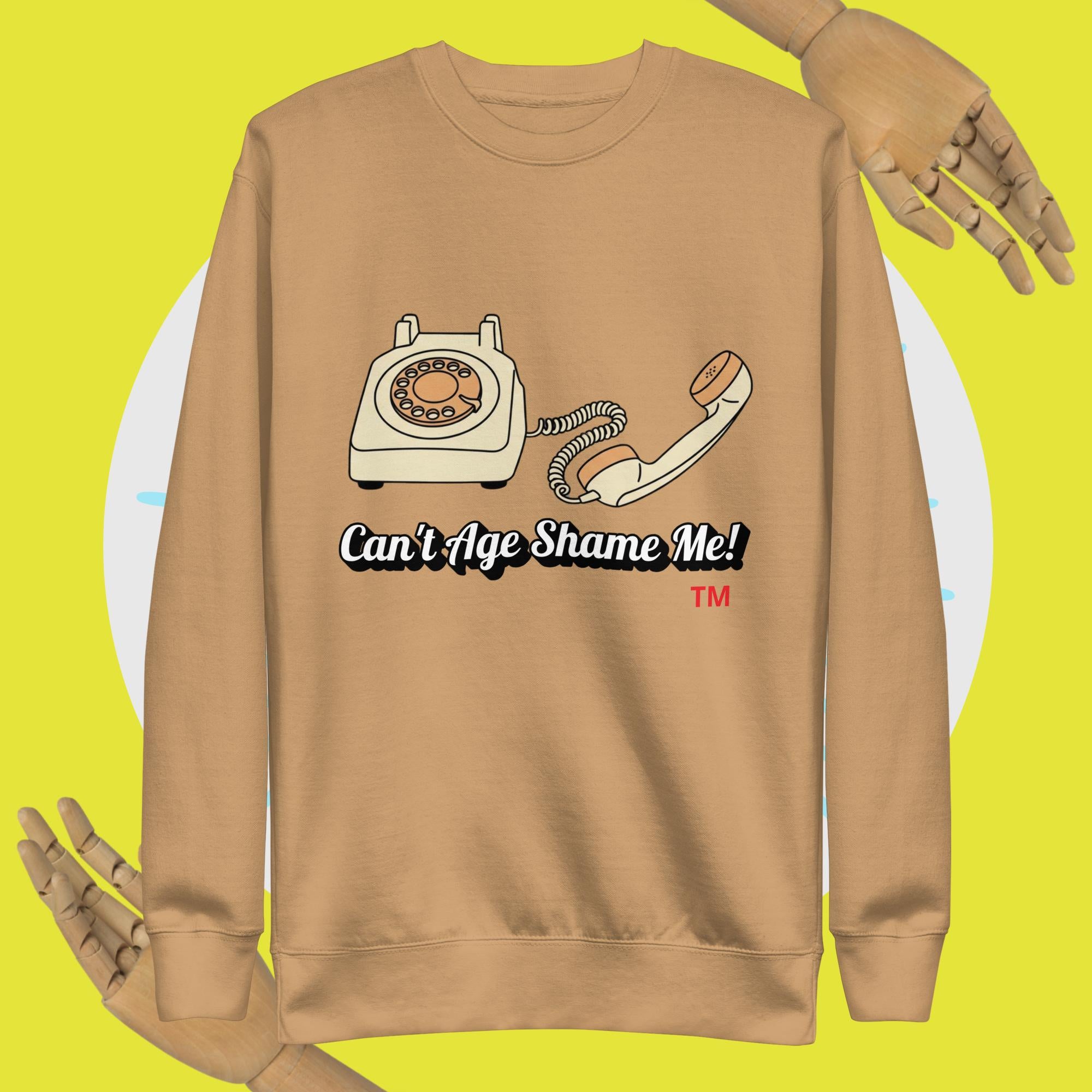 khaki sweatshirt with vintage phone graphic and text 'Can't Age Shame Me!' on a yellow background