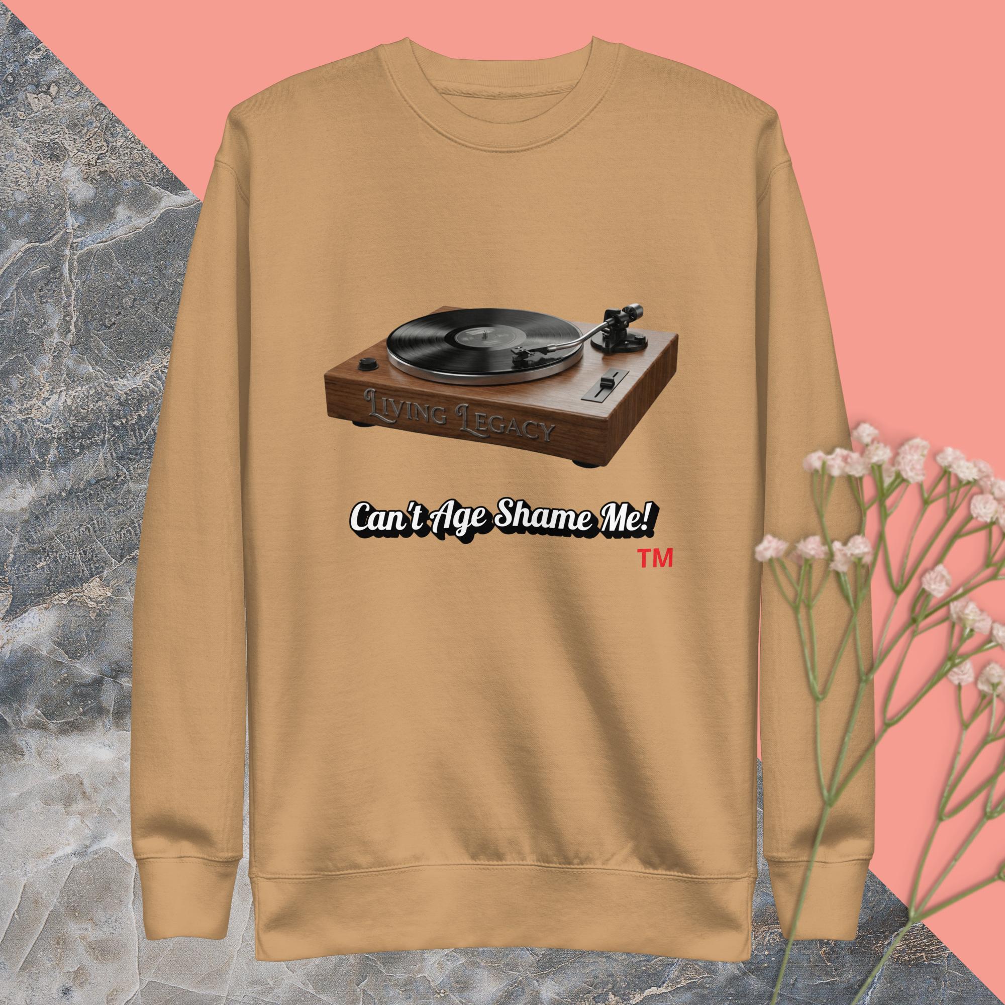 khaki sweatshirt with a graphic of a turntable and text on a pink and gray marble background.