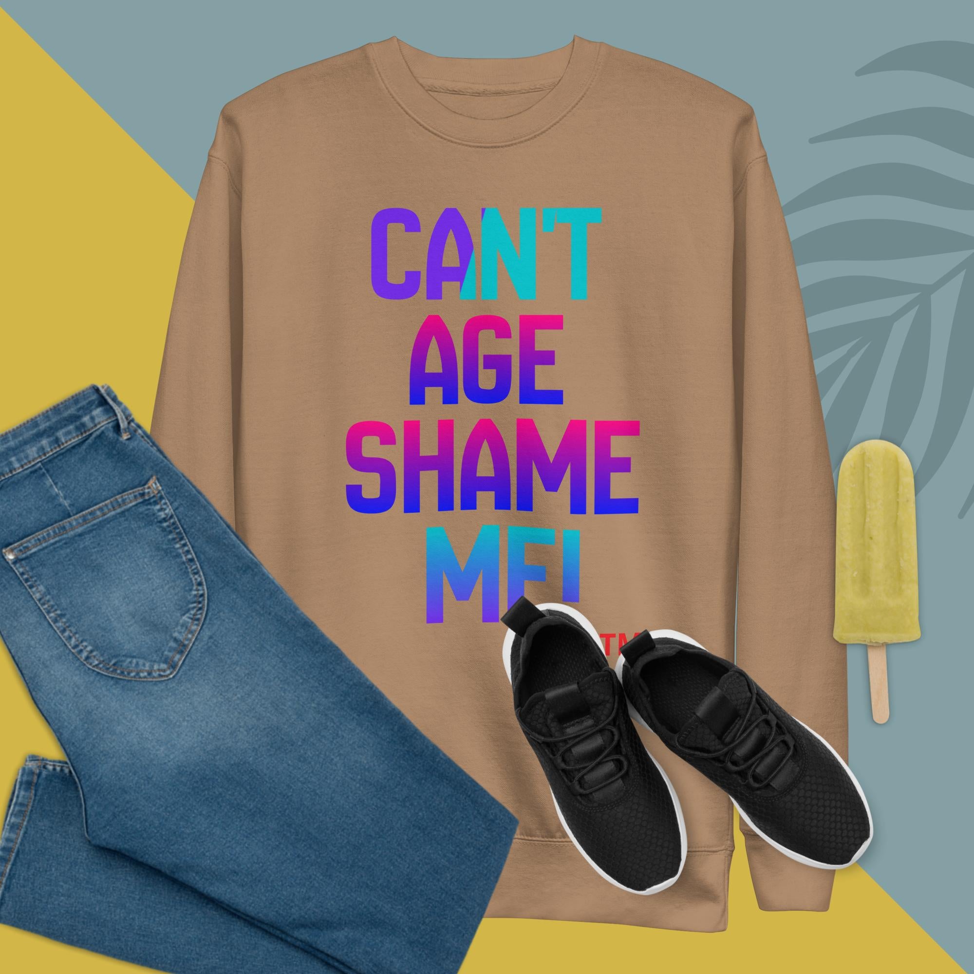 Brown sweatshirt with colorful text, blue jeans, black sneakers, and a popsicle on a multicolored background