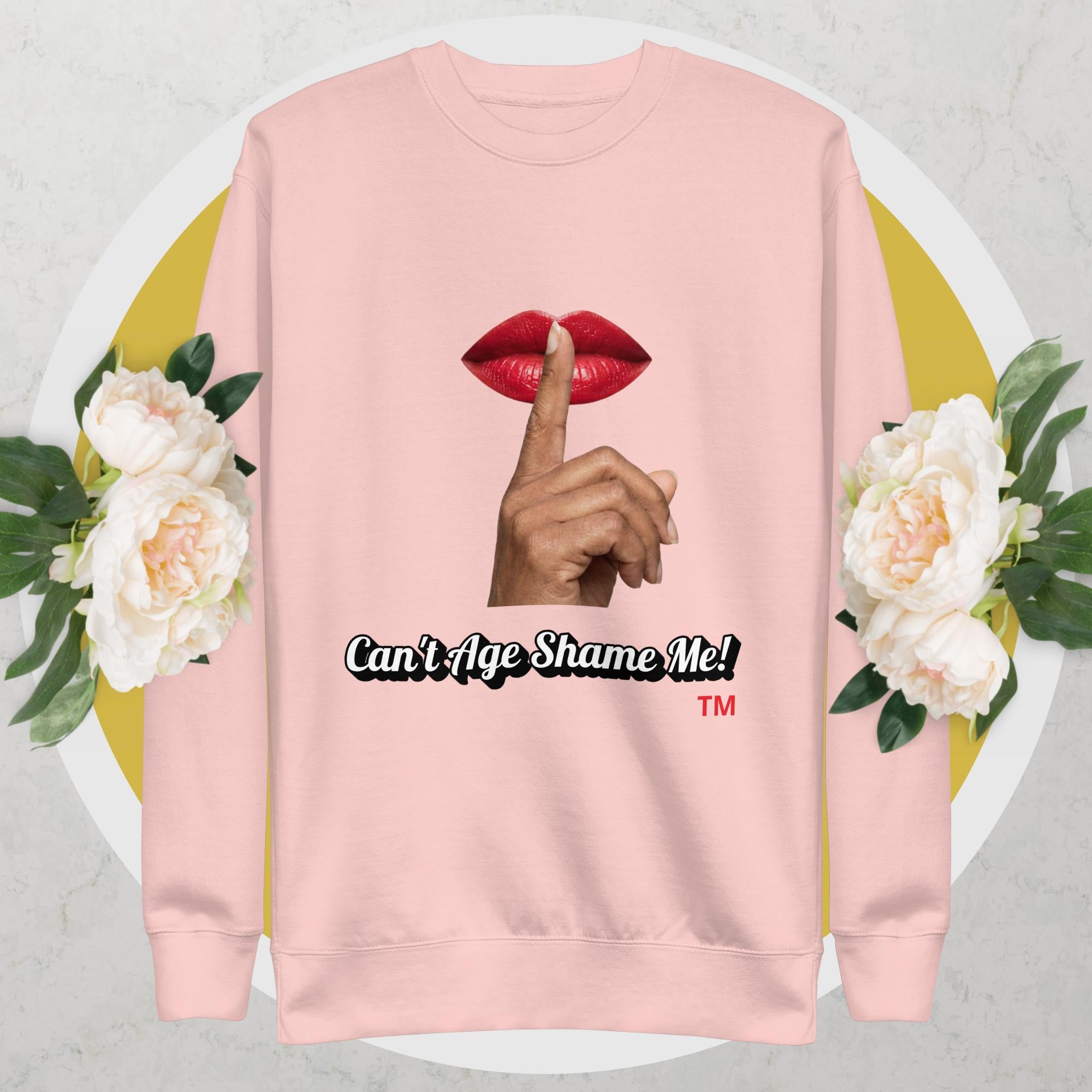 Light Pink sweatshirt with graphic design of a hand, lips, and text 'Can't Age Shame Me!' on a floral background.