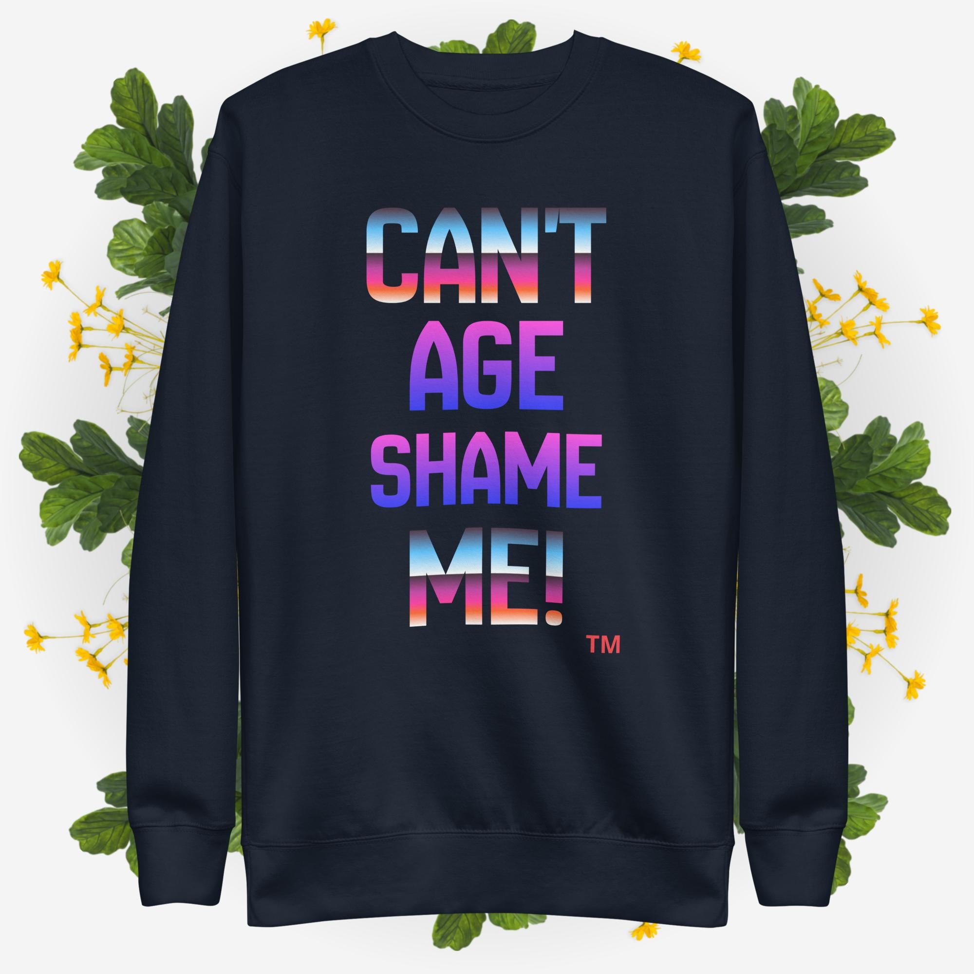Black sweatshirt with colorful text 'CAN'T AGE SHAME ME!' on a floral background