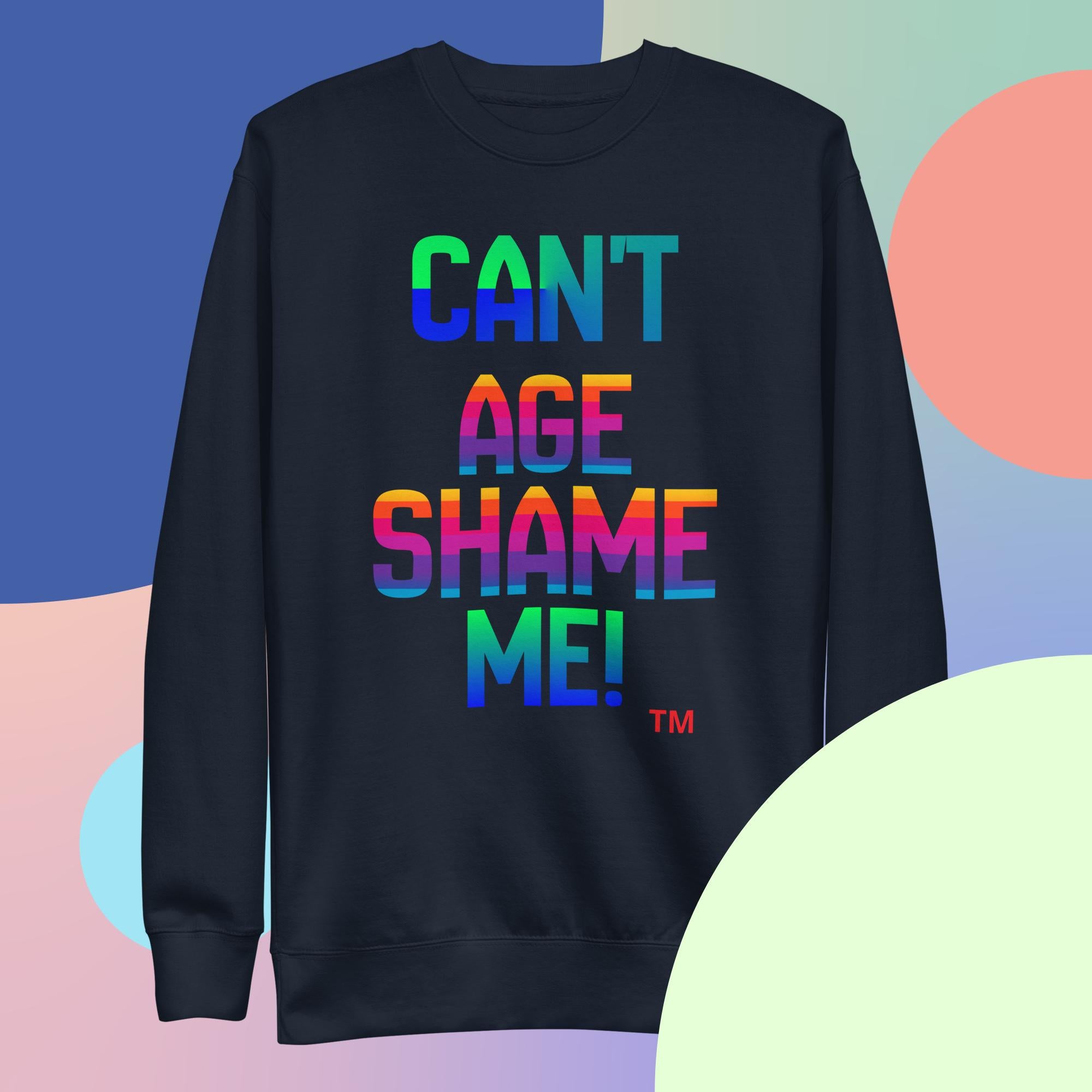 Black sweatshirt with colorful text 'CAN'T AGE SHAME ME!' on a multicolored background
