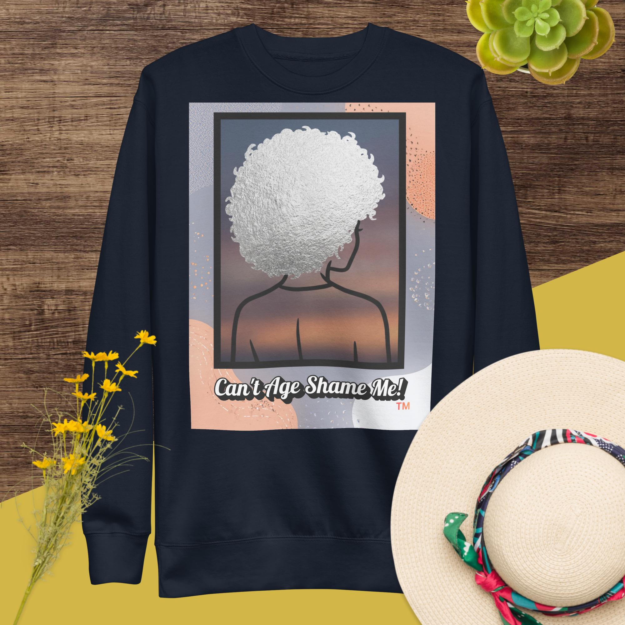 Dark Gray sweatshirt with a graphic design of a person with textured hair and text 'Can't Age Shame Me!' on a colorful background.