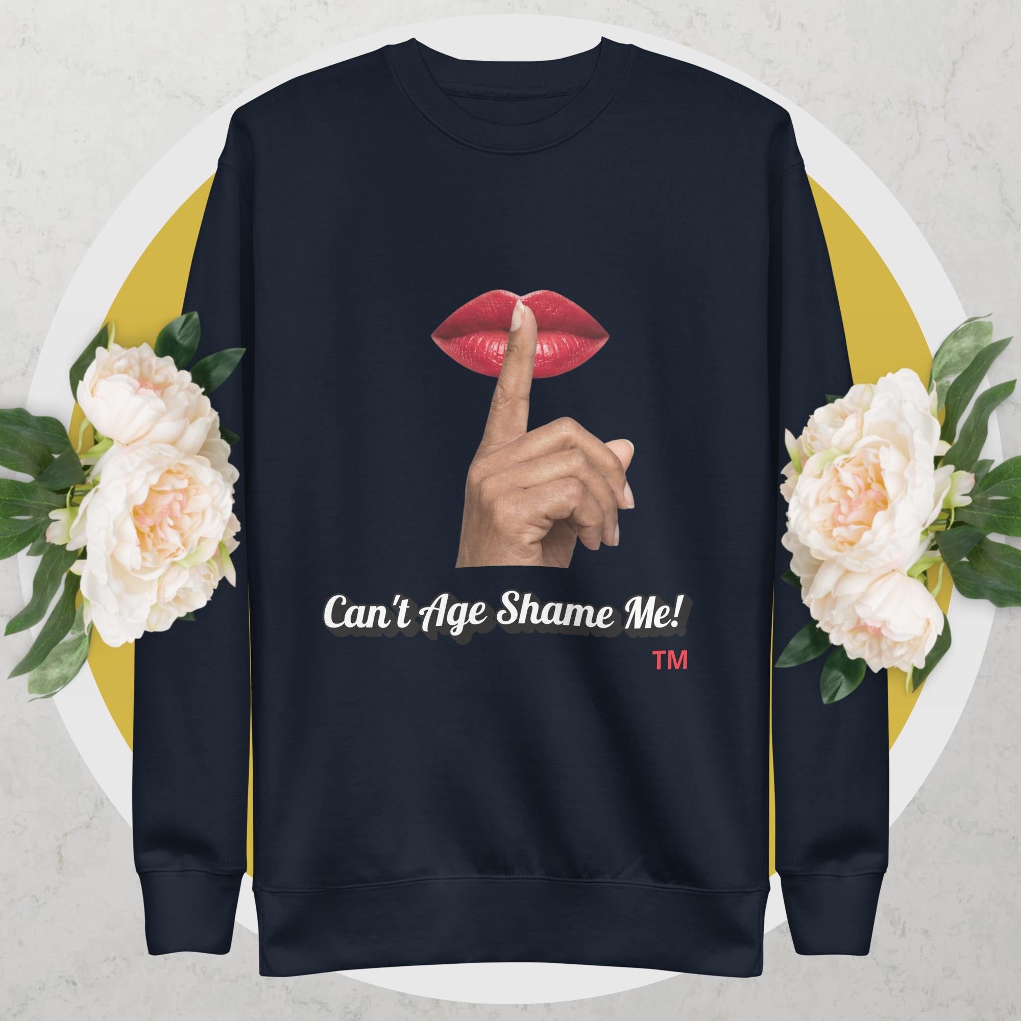 Navy sweatshirt with graphic design of a hand, lips, and text 'Can't Age Shame Me!' on a floral background.