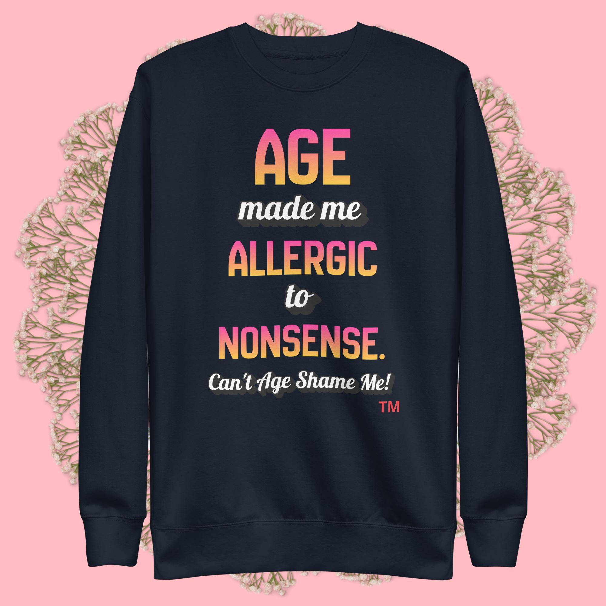 Navy blue sweatshirt with colorful text on a pink background
