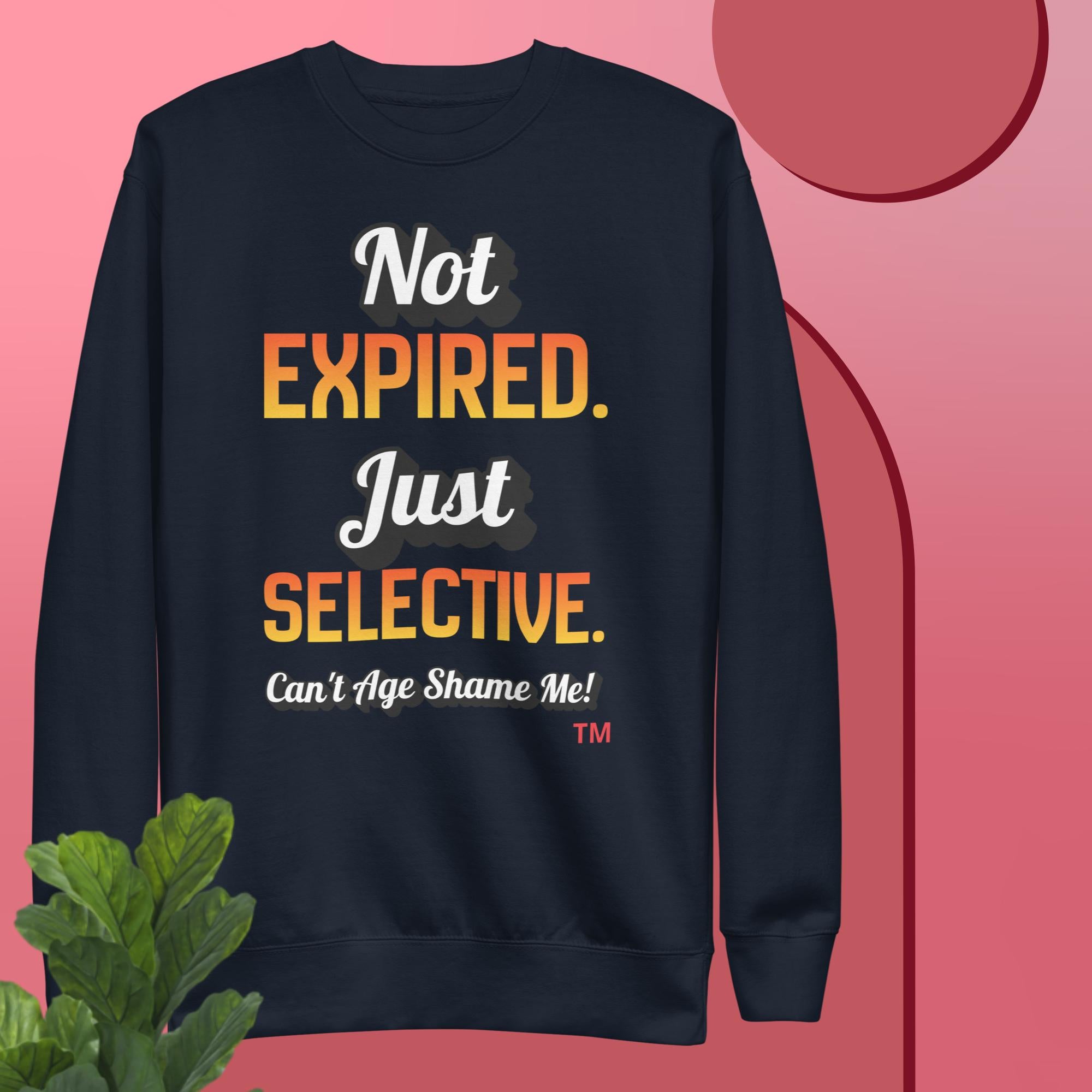 Navy sweatshirt with colorful text on a pink background