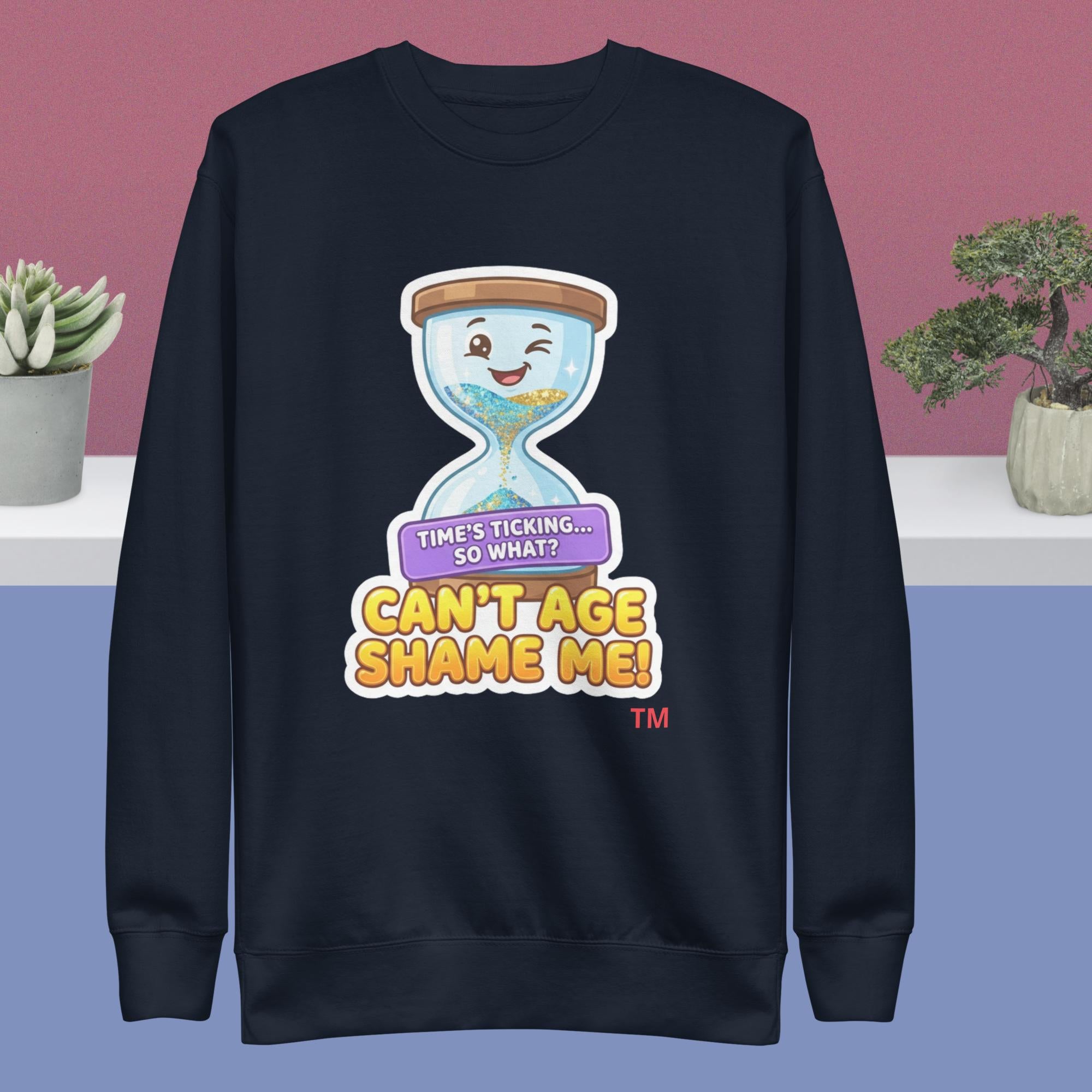 Navy sweatshirt with a cartoon hourglass design and humorous text on a pink and blue gradient background.