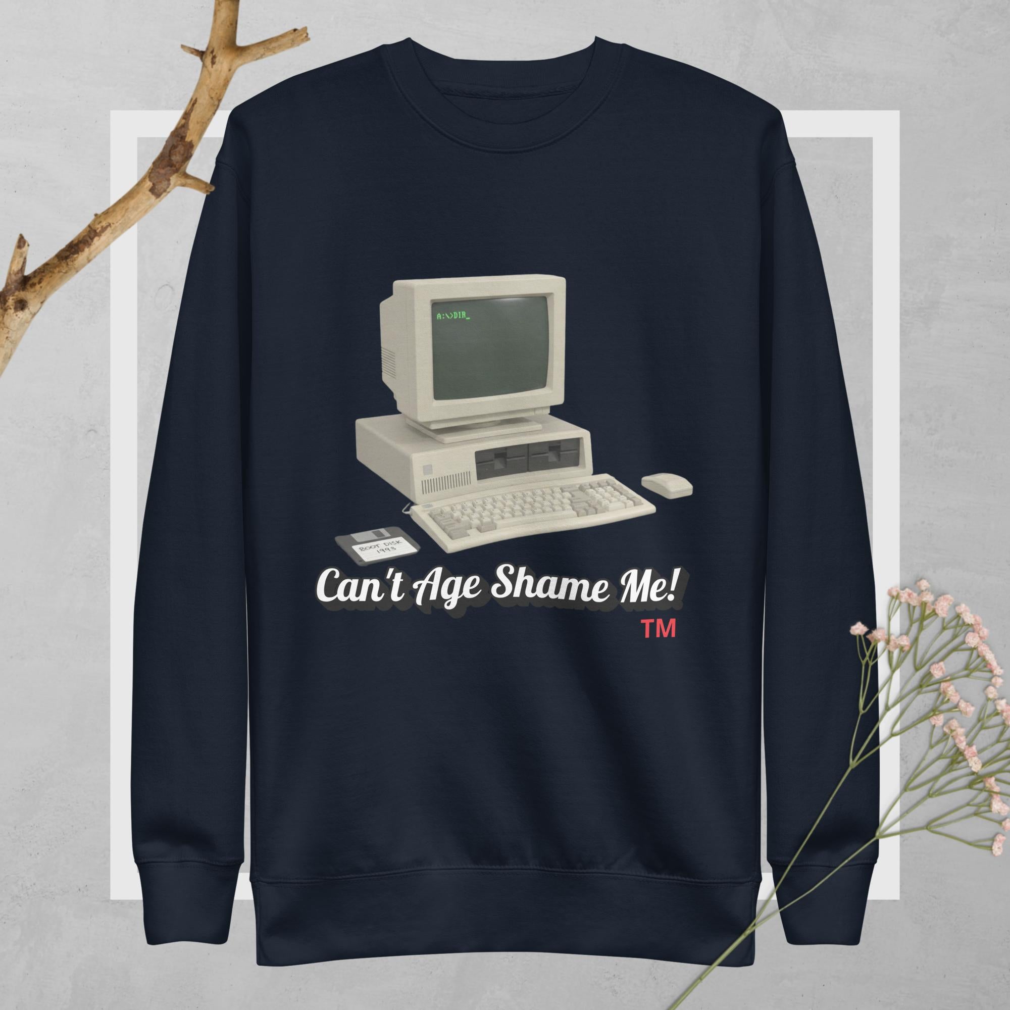 Navy blue sweatshirt with vintage computer graphic and text 'Can't Age Shame Me!' on a light gray background.