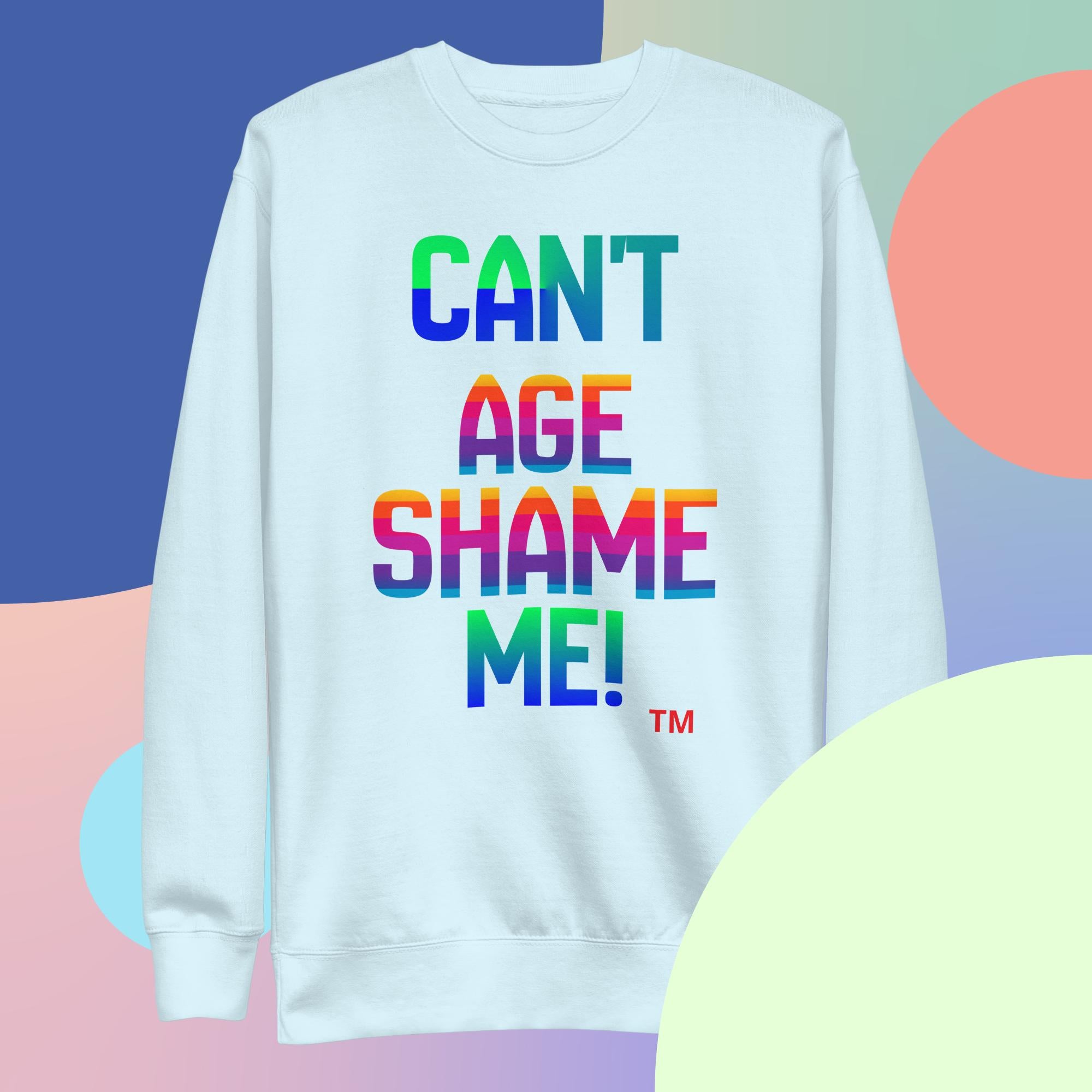 White sweatshirt with colorful text 'CAN'T AGE SHAME ME!' on a multicolored background