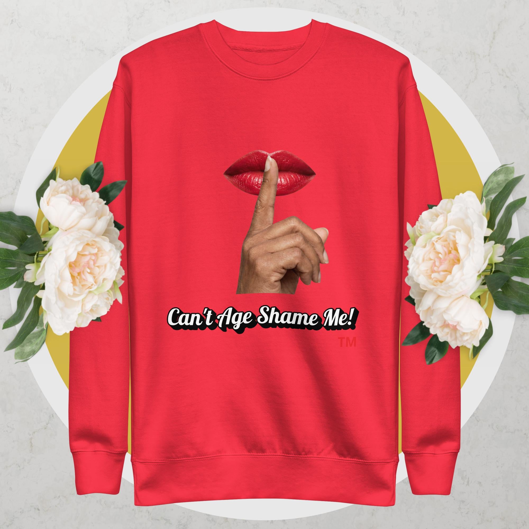 Team Red sweatshirt with graphic design of a hand, lips, and text 'Can't Age Shame Me!' on a floral background. 