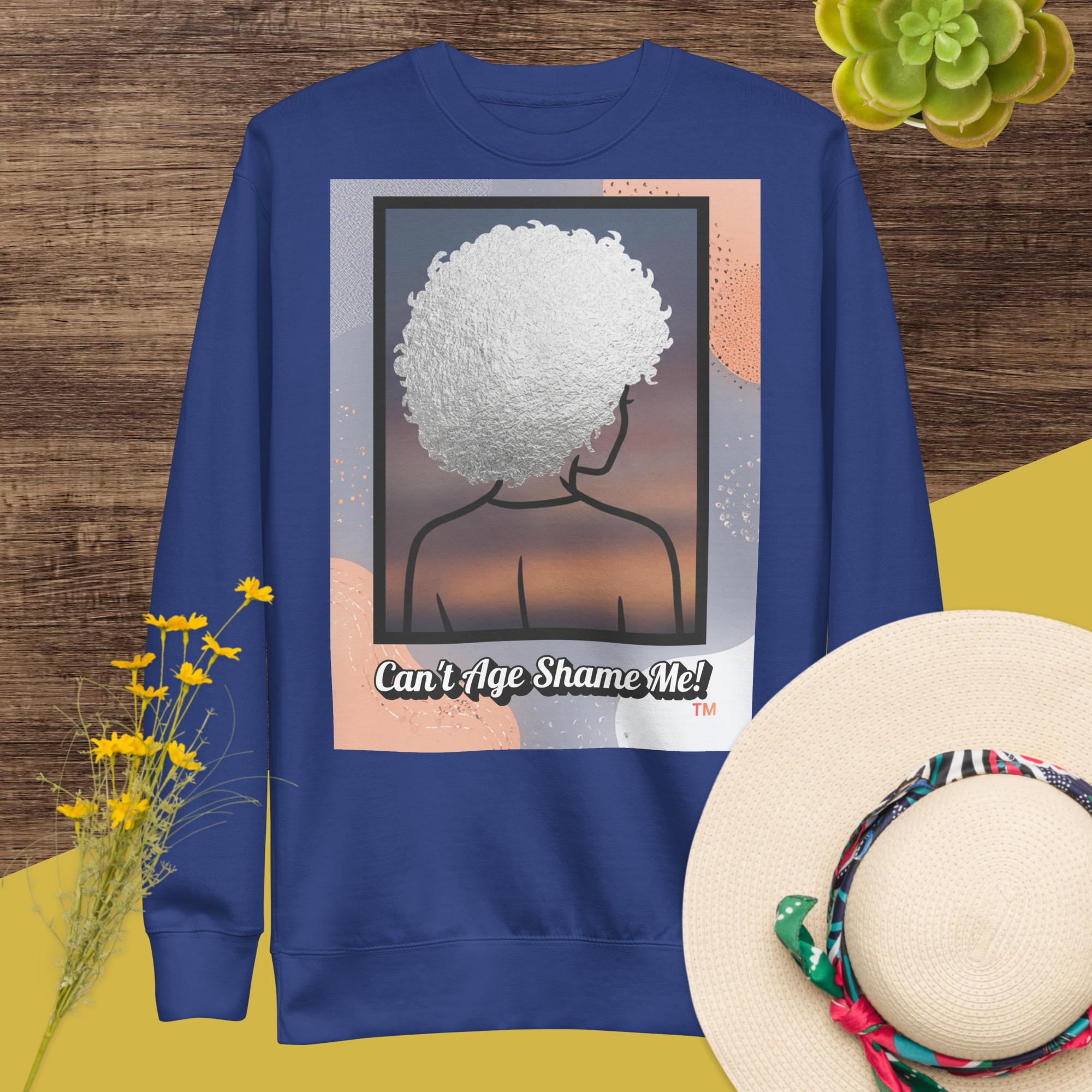 Royal Blue sweatshirt with a graphic design of a person with textured hair and text 'Can't Age Shame Me!' on a colorful background.