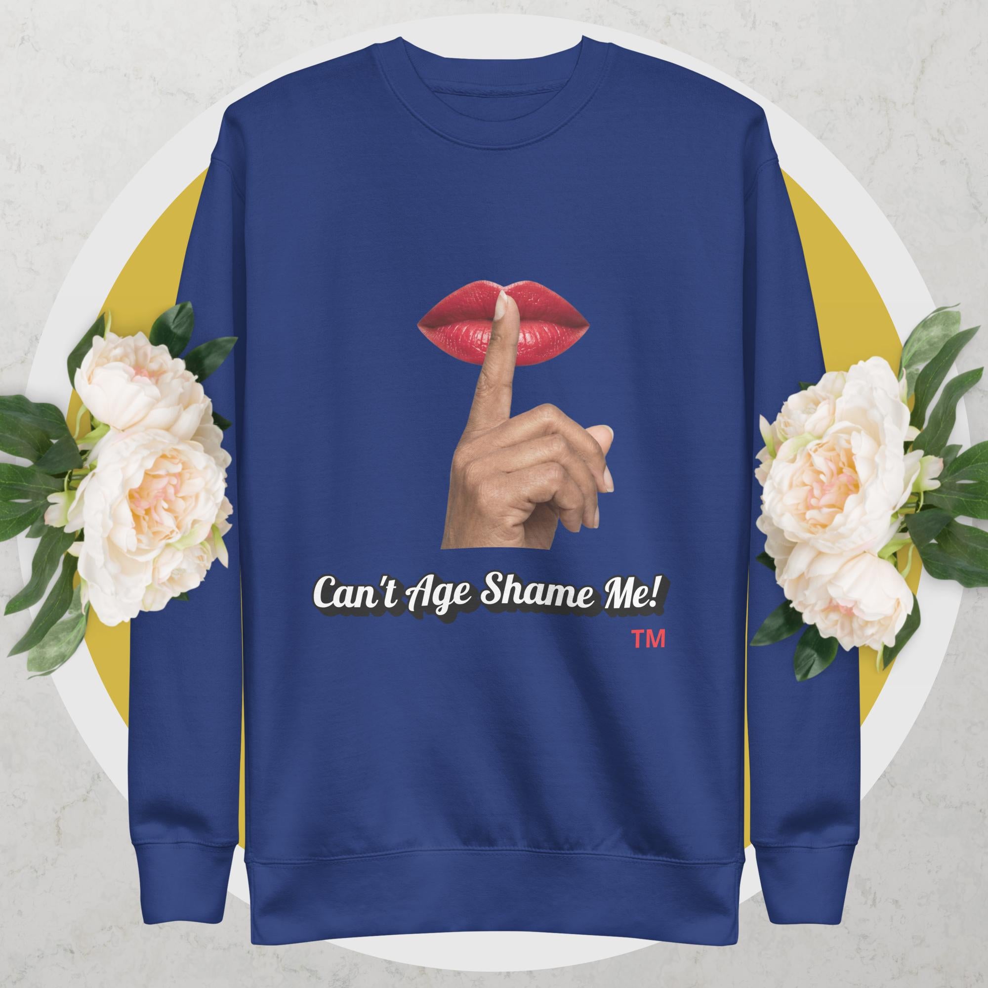 Team Royal sweatshirt with graphic design of a hand, lips, and text 'Can't Age Shame Me!' on a floral background.
