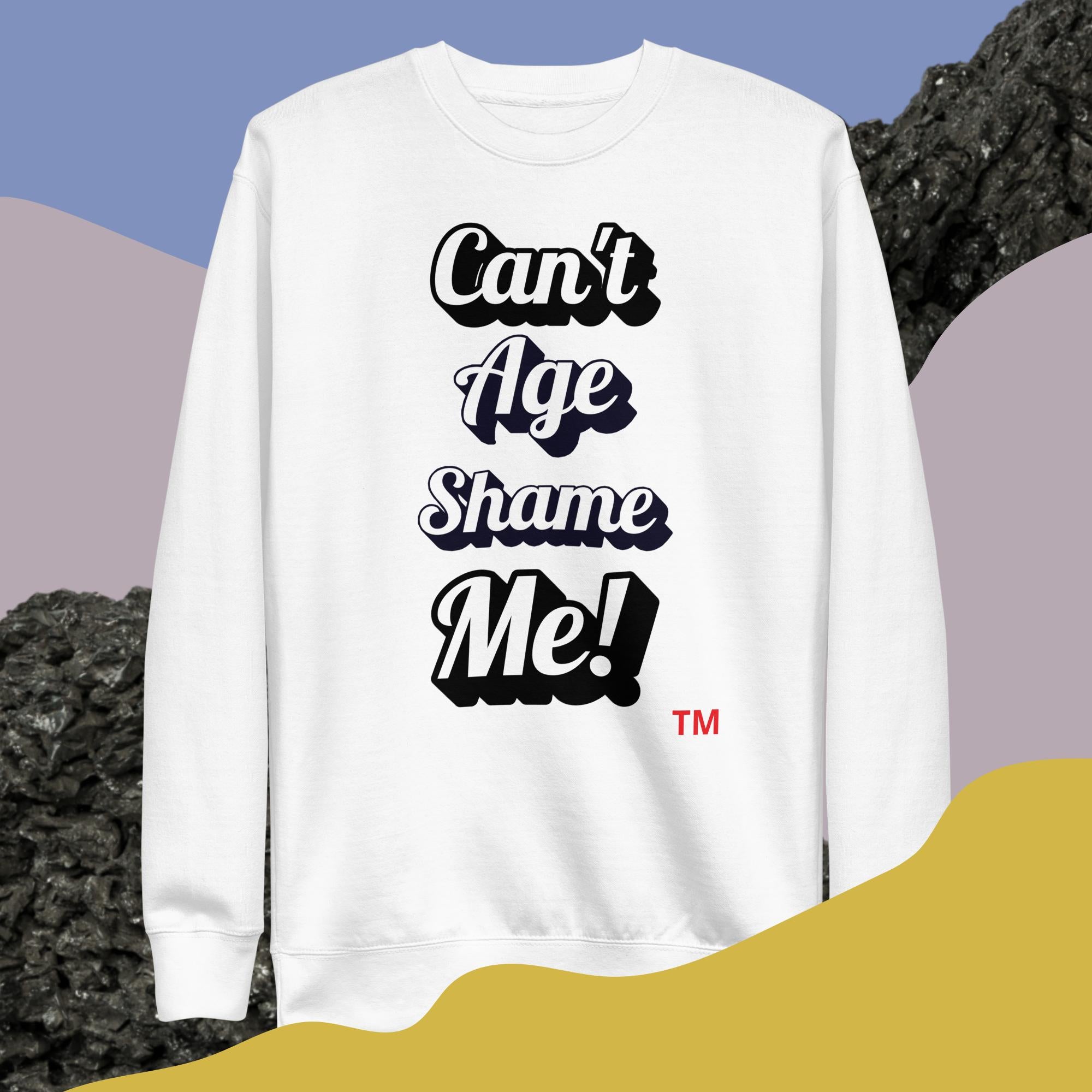 White sweatshirt with 'Can't Age Shame Me!' text on a colorful abstract background