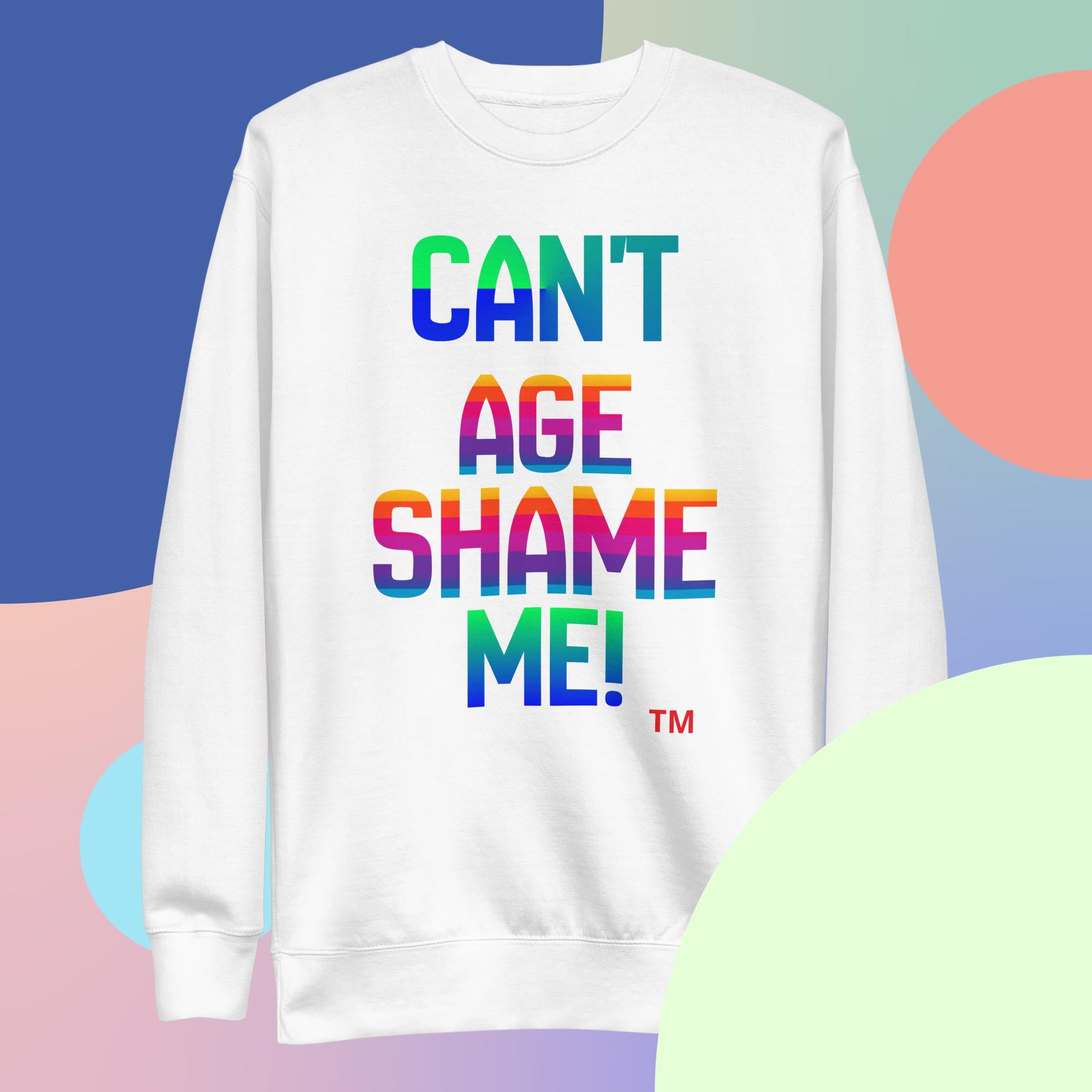 White sweatshirt with colorful text 'CAN'T AGE SHAME ME!' on a multicolored background