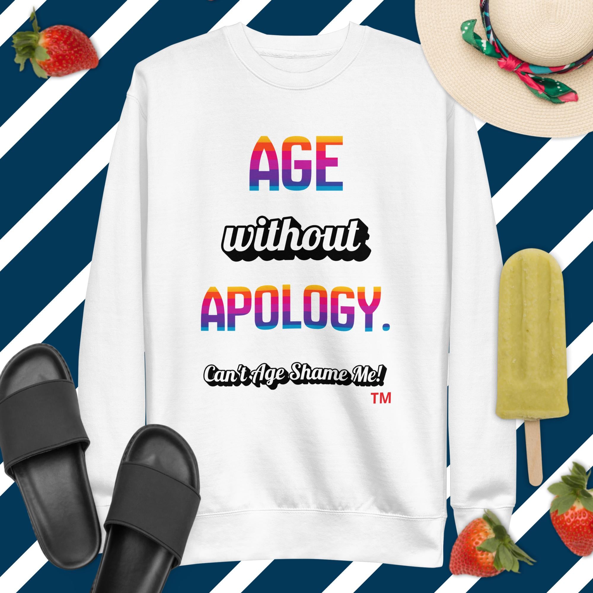 White sweatshirt with colorful text on a blue and white striped background with accessories.