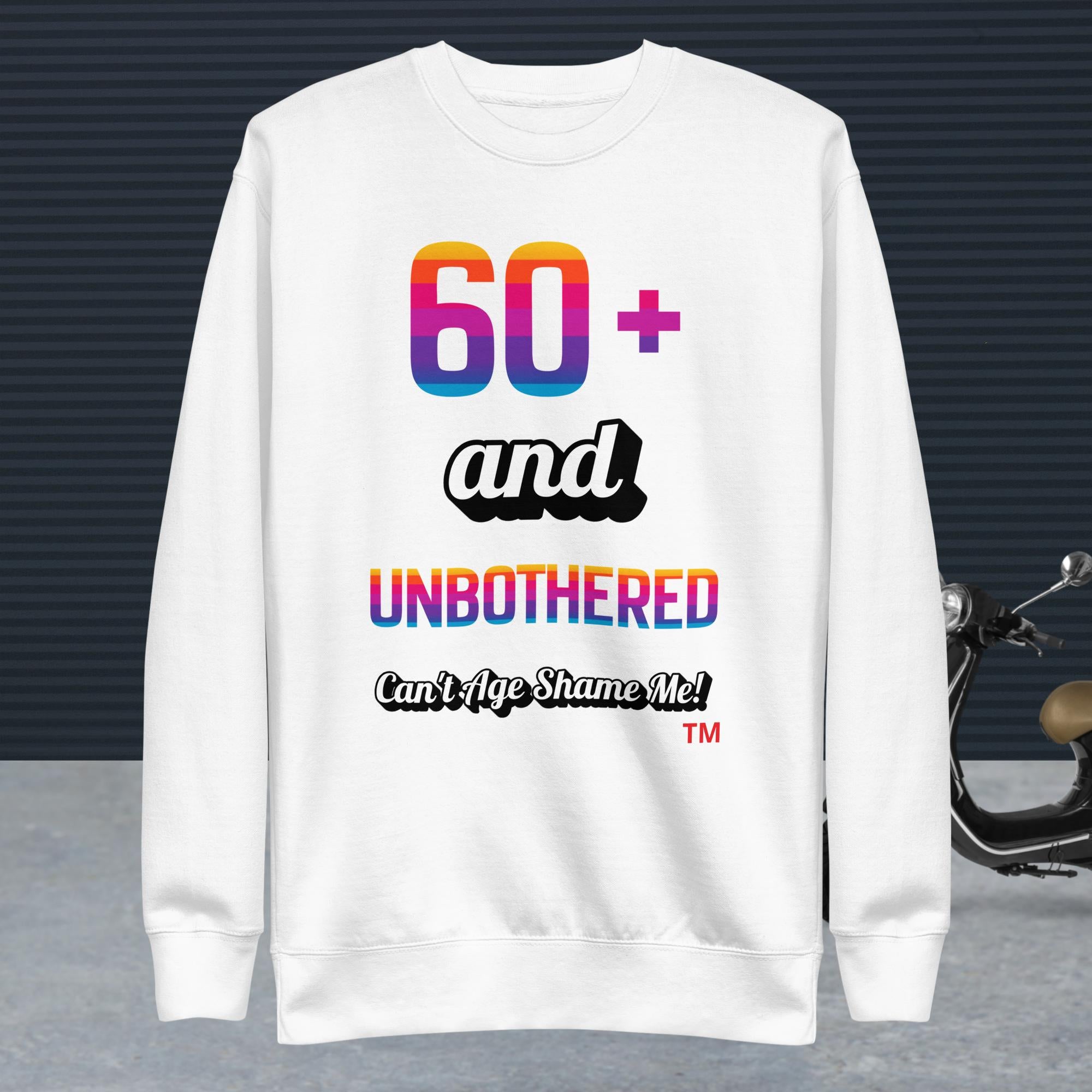 White sweatshirt with colorful text design on a dark background
