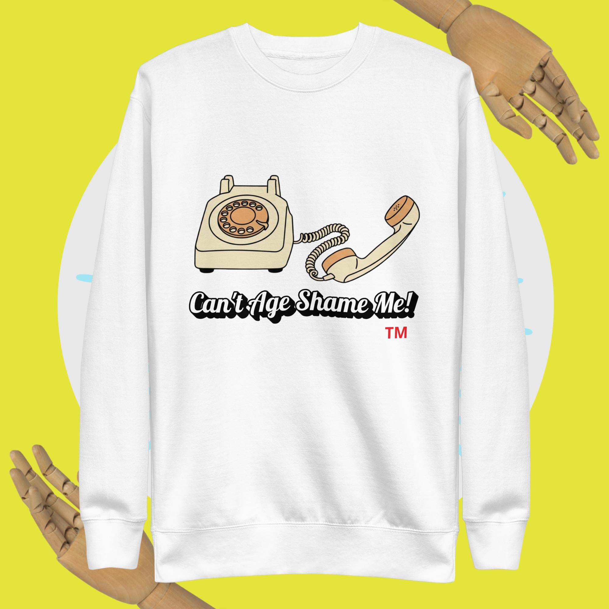 White sweatshirt with vintage phone graphic and 'Can't Age Shame Me!' text on a yellow background