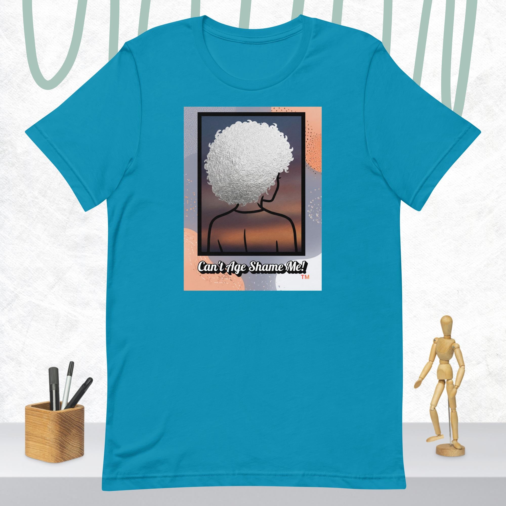 Aqua t-shirt with a graphic of a person with an afro and text 'Can't Age Shame Me!' on a white background.
