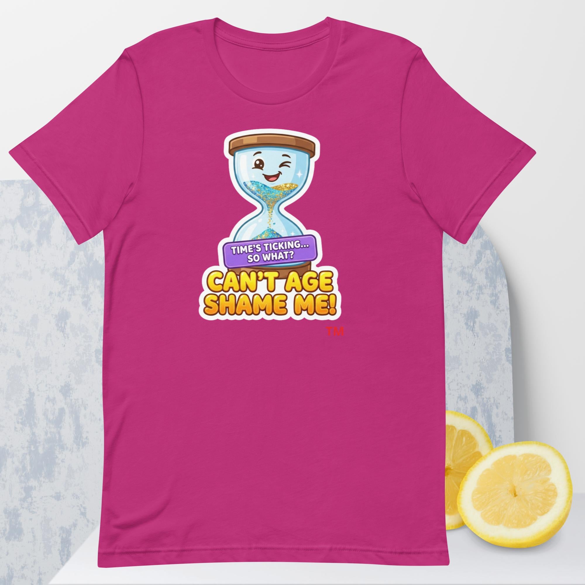 Berry  t-shirt with a cartoon hourglass design and text 'Can't Age Shame Me' graphic on a light gray background.


