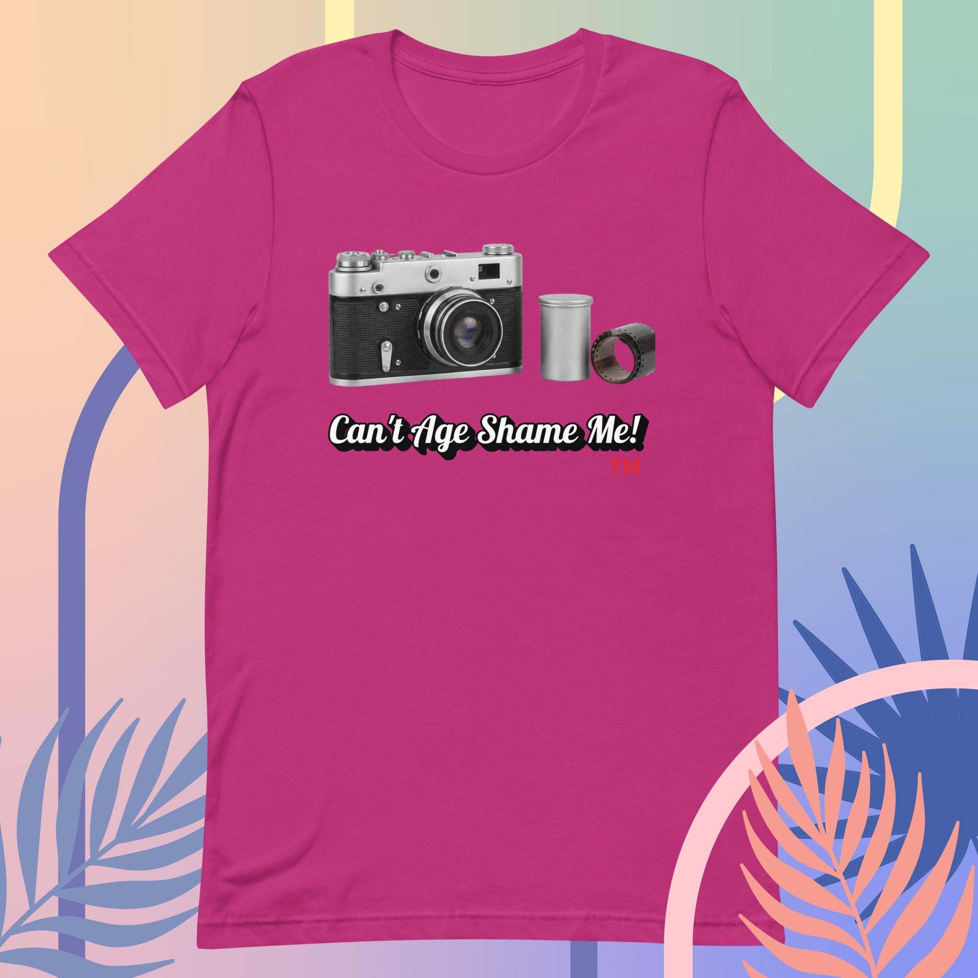 berry t-shirt with a camera graphic and text 'Can't Age Shame Me!' on a colorful background.