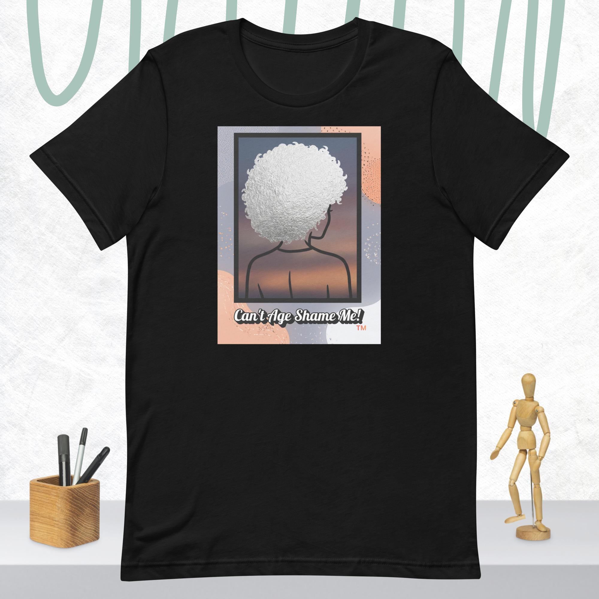 Black  t-shirt with a graphic of a person with an afro and text 'Can't Age Shame Me!' on a white background.