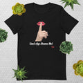 Black t-shirt with graphic design of finger on mouth and text 'CAN'T AGE SHAME ME!' text logo on a light gray background with succulents.