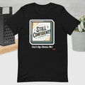 Black t-shirt with 'Still Confident! Can't Age Shame Me!' graphic design on a neutral background